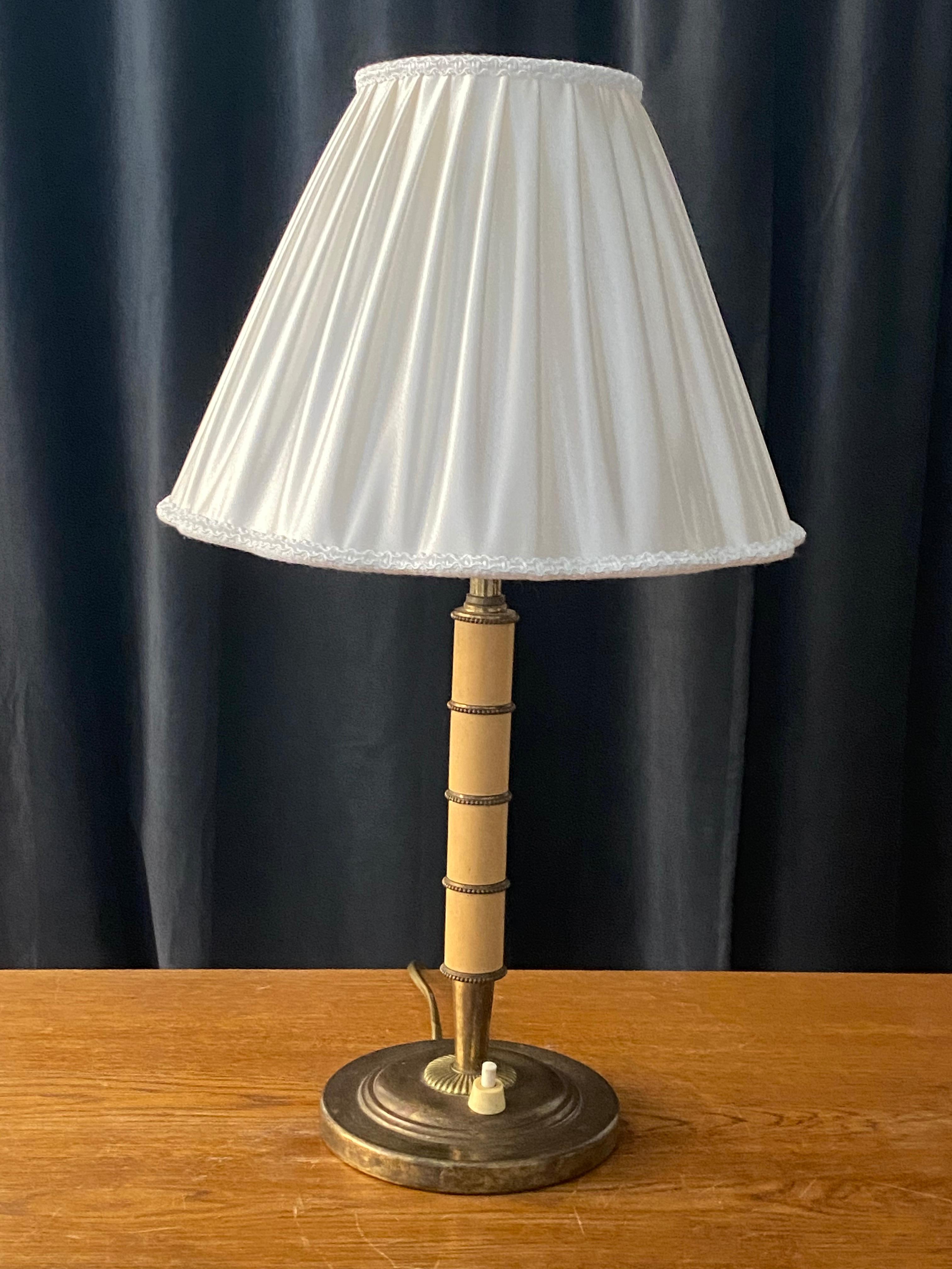 A table lamp, designed and produced in Sweden, 1930s. With lively original patina. With a brand new high-end lampshade produced in Sweden

Other designers of the period include Josef Frank, Estrid Ericsson, Just Andersen, and Kaare Klint.
  