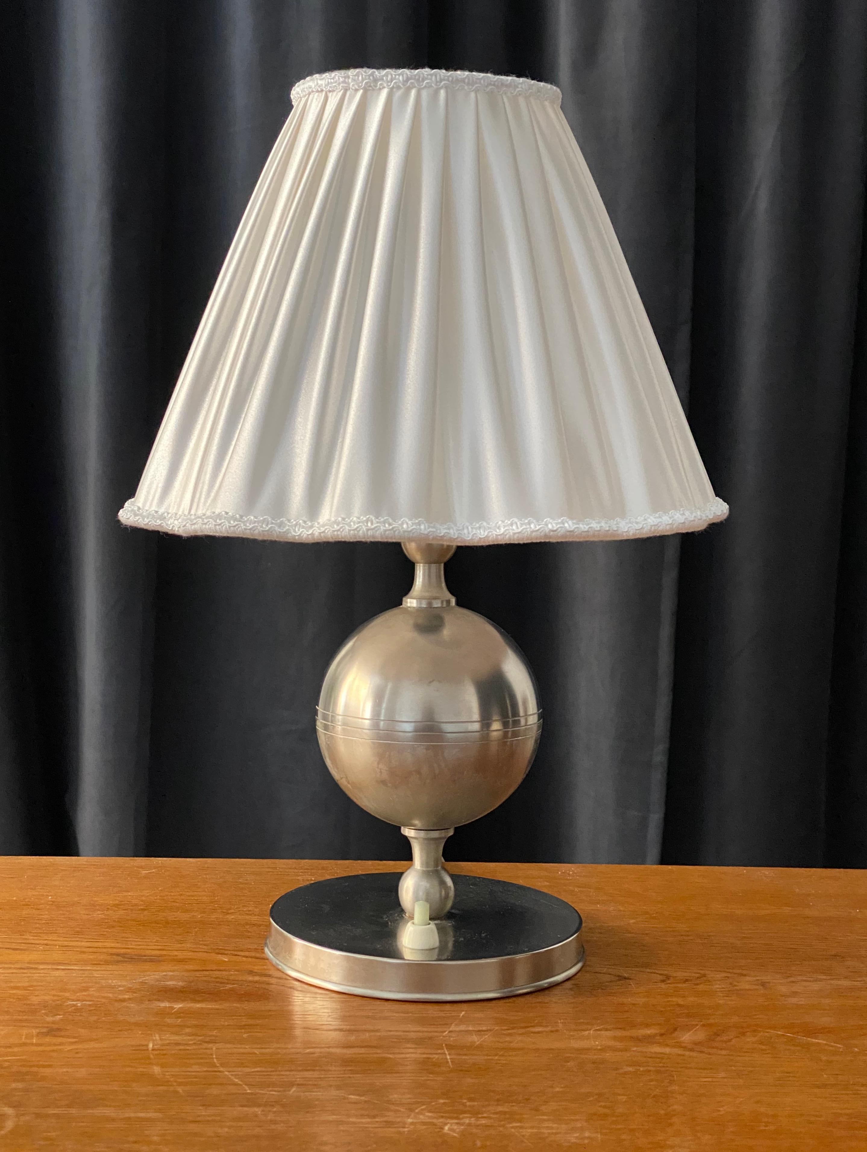 A small table lamp, designed and produced in Sweden, 1930s. With lively original patina. With a brand new high end lampshade produced in Sweden

Other designers of the period include Josef Frank, Estrid Ericsson, Just Andersen, and Kaare