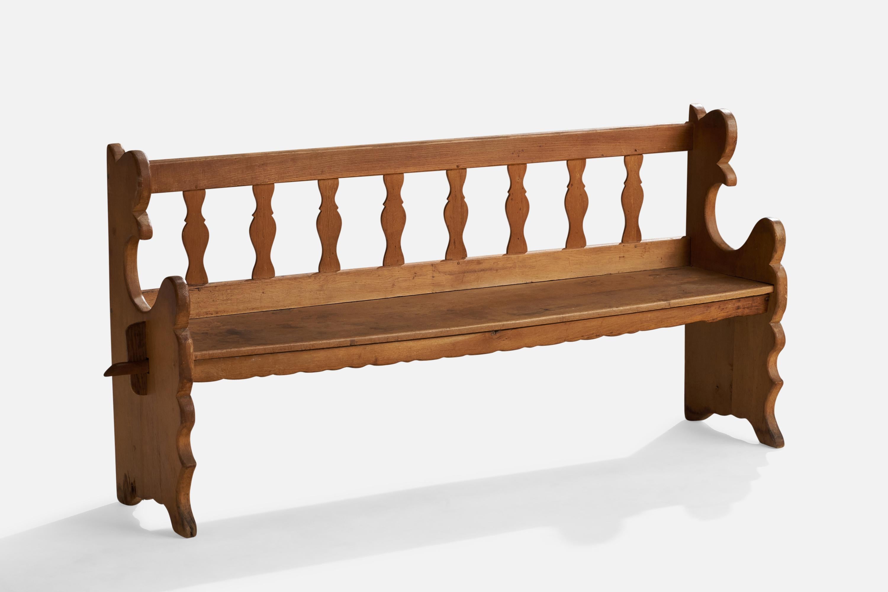 An oak bench designed and produced in Sweden, c. 1920s.

Seat height 18.25