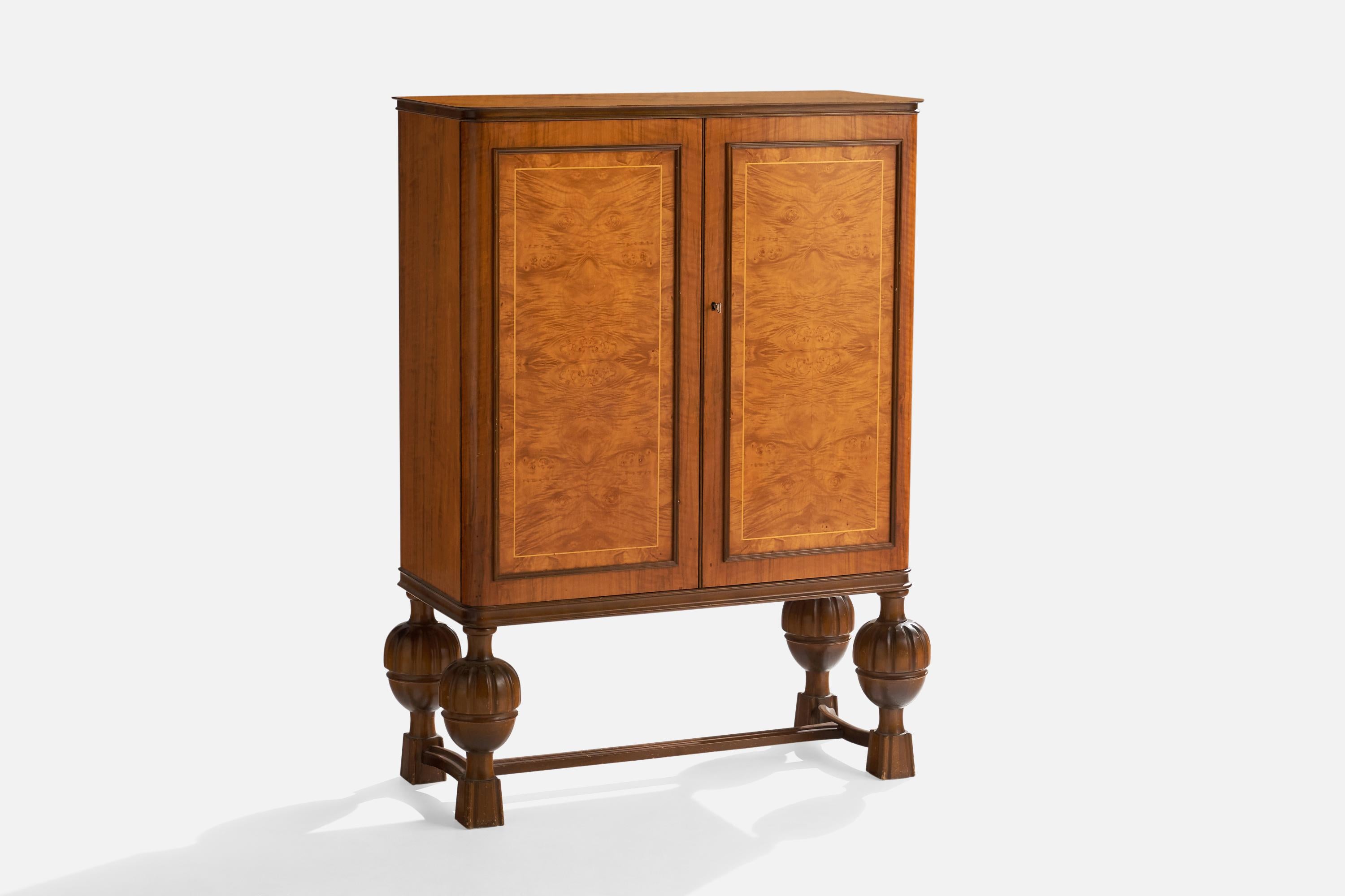 A elm and birch cabinet designed and produced in Sweden, c. 1920s.