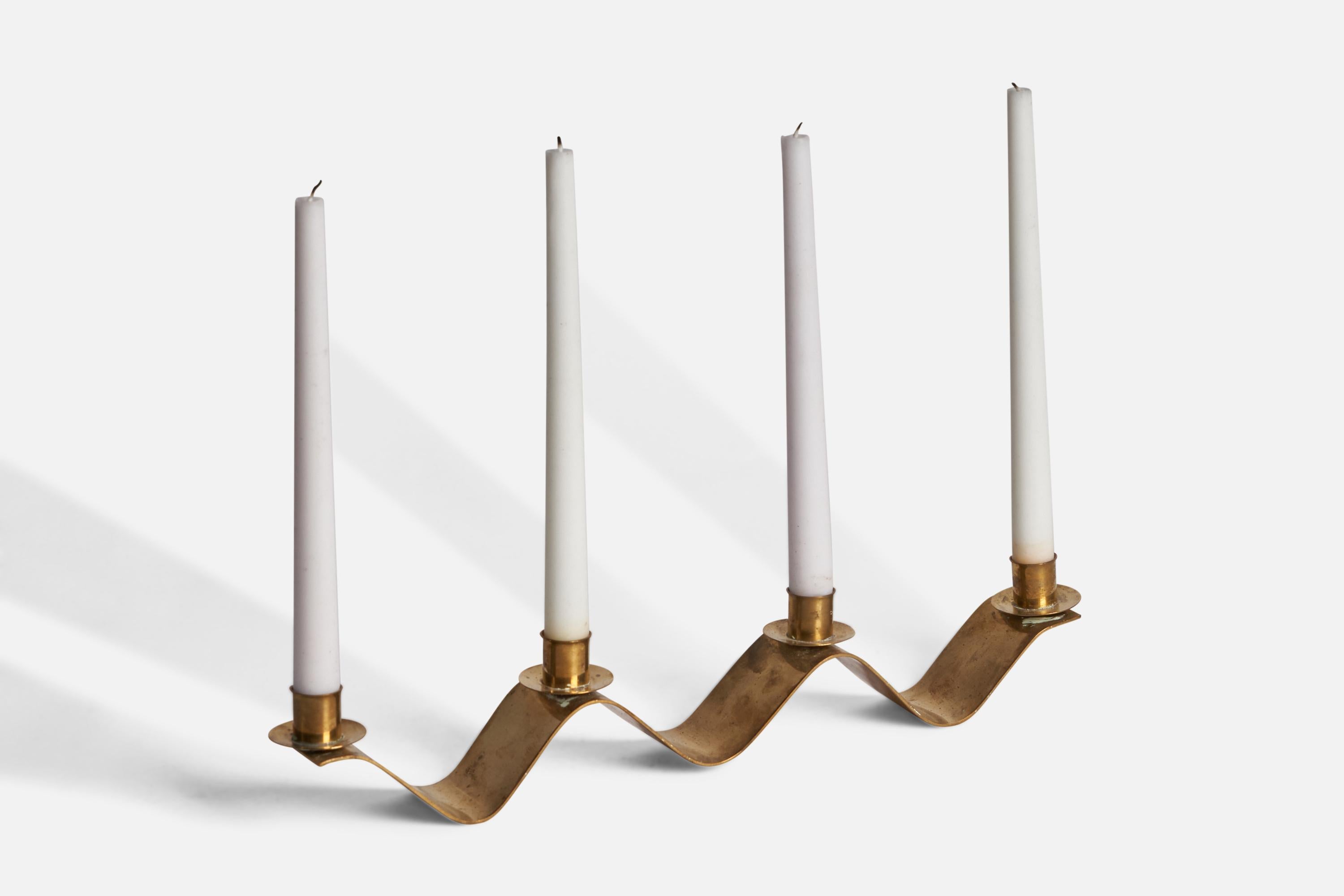 An organic brass candelabra, designed and produced in Sweden, c. 1940s.

Holds 0.92” x 0.78” diameter candles