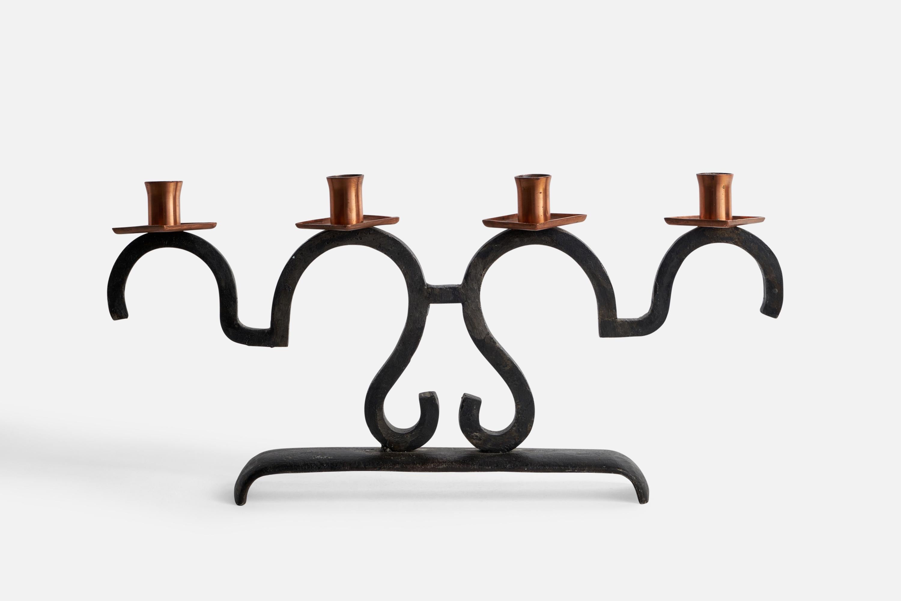 A black-painted cast iron and copper candelabra, designed and produced in Sweden, c. 1940s.

Holds 0.8” diameter candles