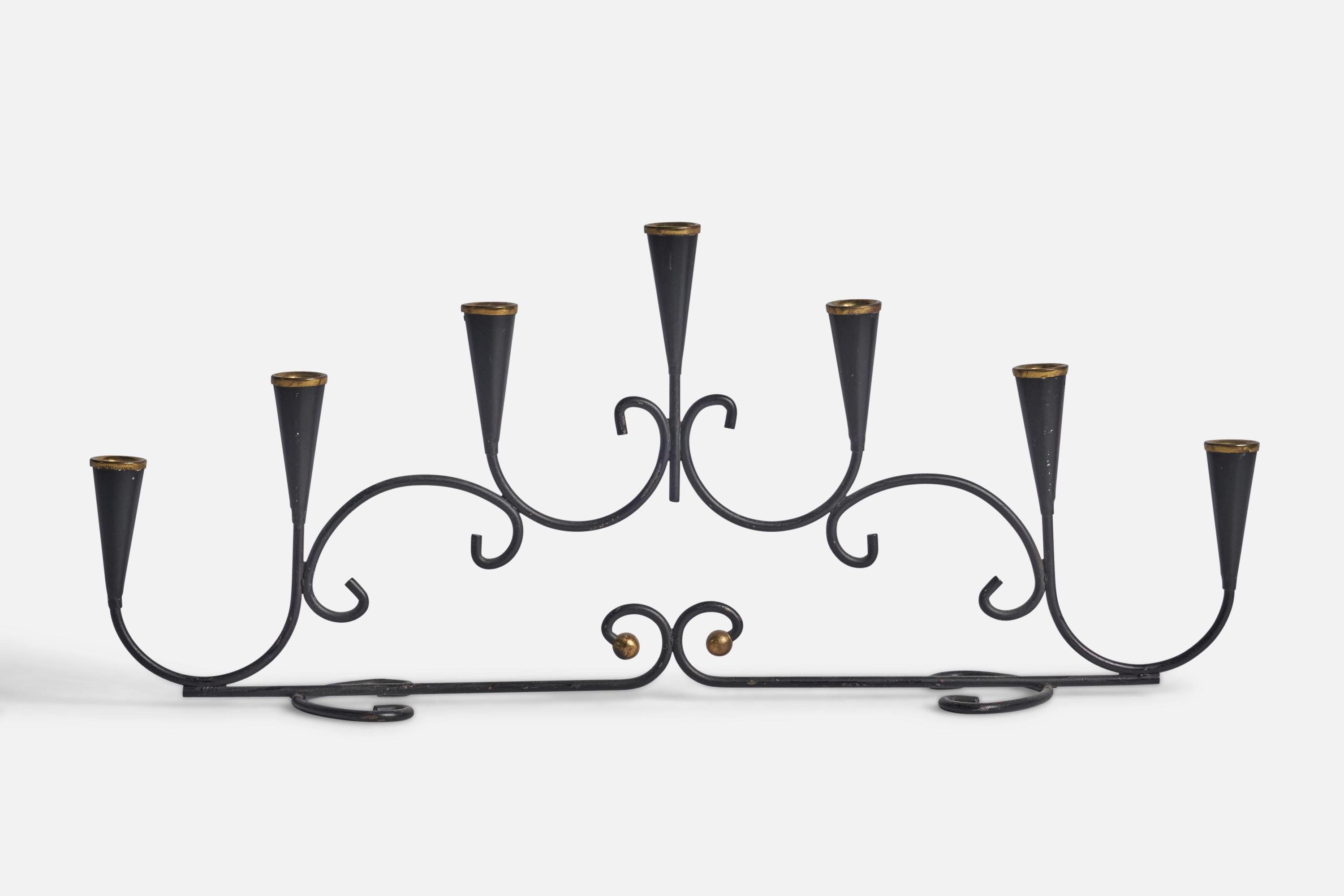 A black-painted metal and brass candelabra designed and produced in Sweden, 1960s.

Holds 0.5” candles