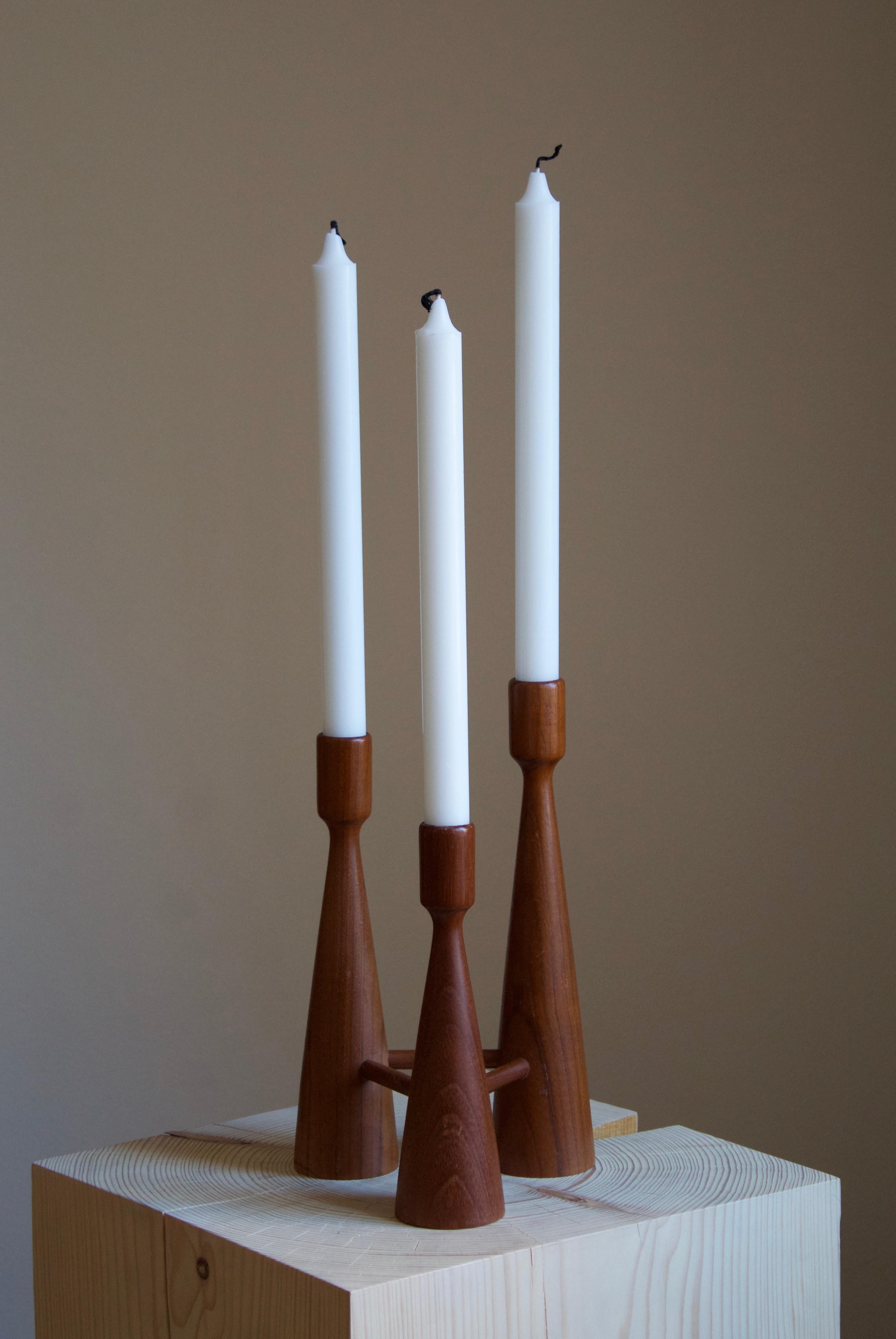 A candelabra, designed and produced in Sweden, 1950s. In turned solid teak.