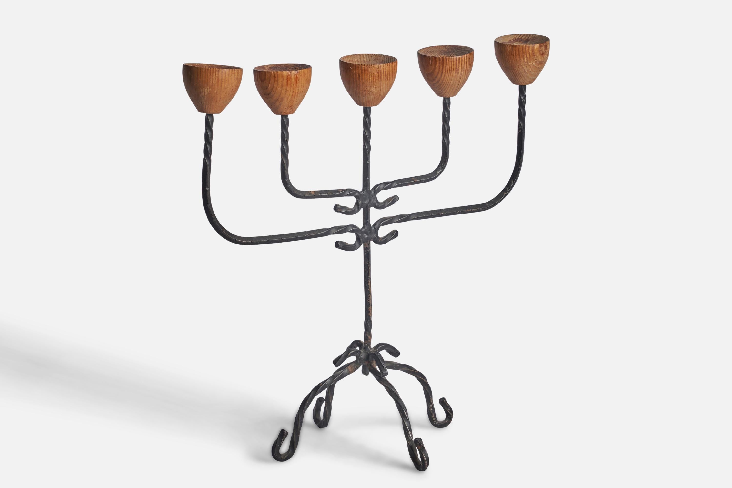 A wrought iron and oak candelabra designed and produced in Sweden, 1960s.

Fits 0.75” diameter candles