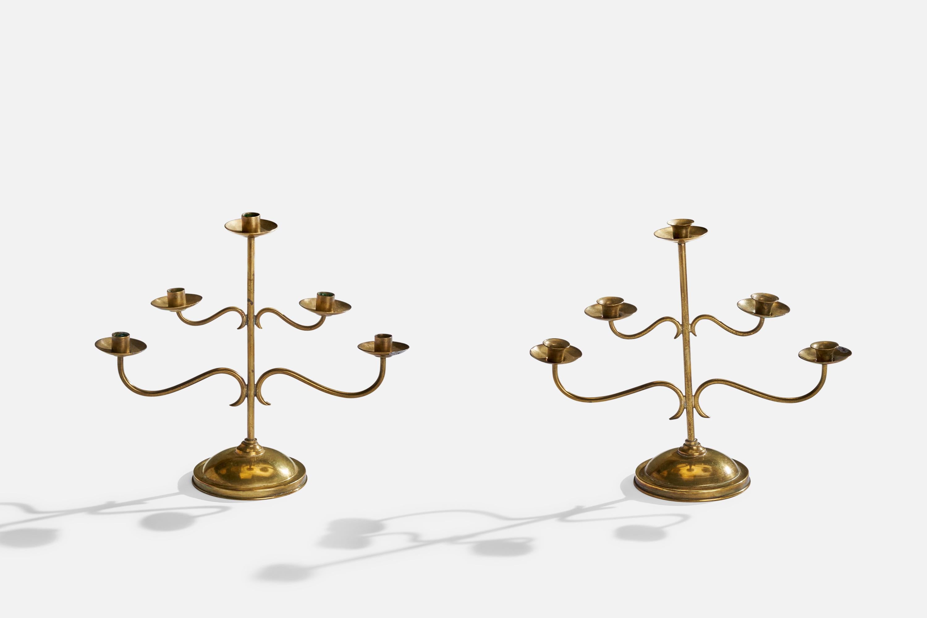 A pair of brass candelabras designed and produced in Sweden, c. 1940s.

Hold .75” candles

Near identical pair, please note difference to shape of nozzles.