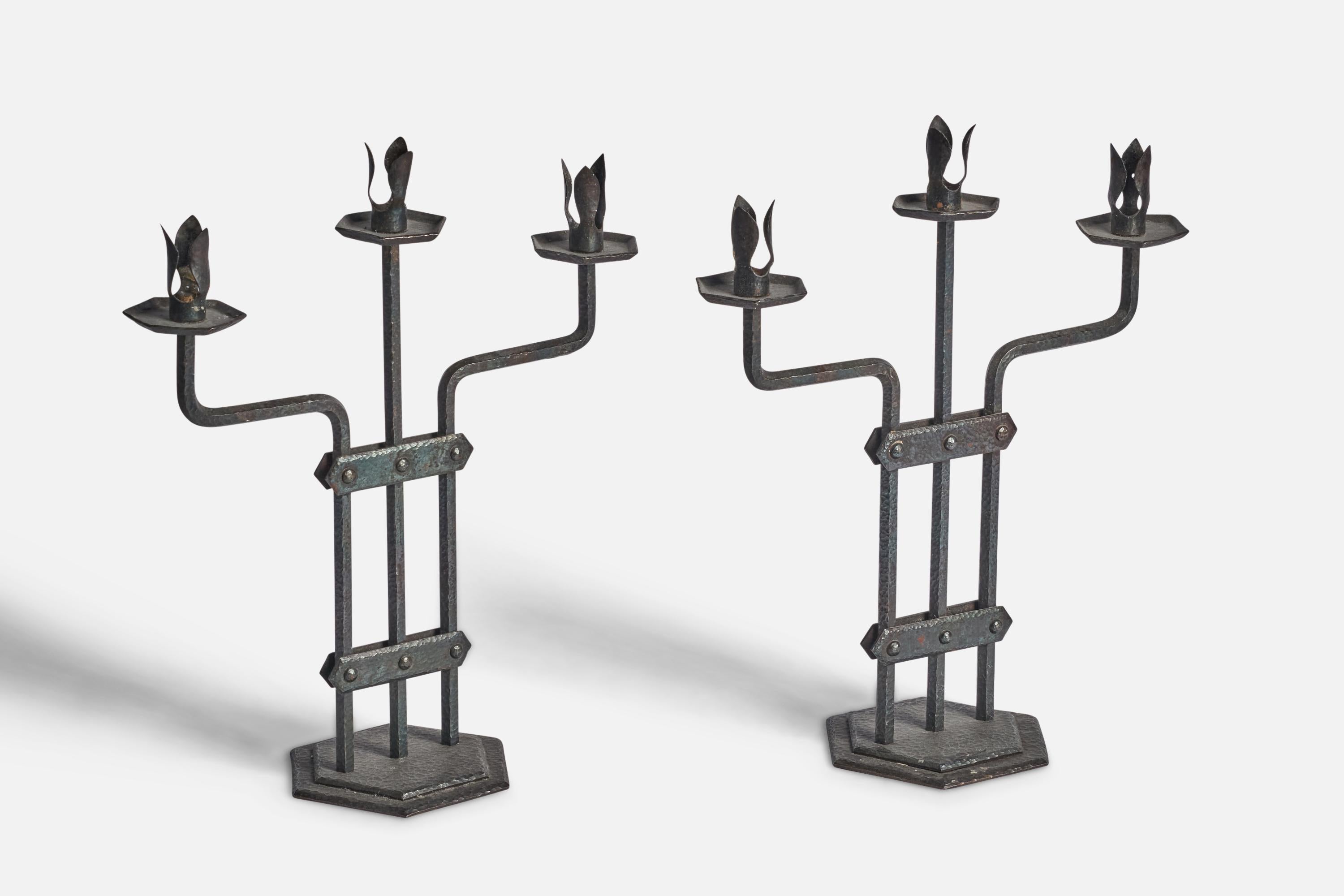 A pair of iron candelabras designed and produced in Sweden, c. 1940s.

fits 0.75” diameter candles
