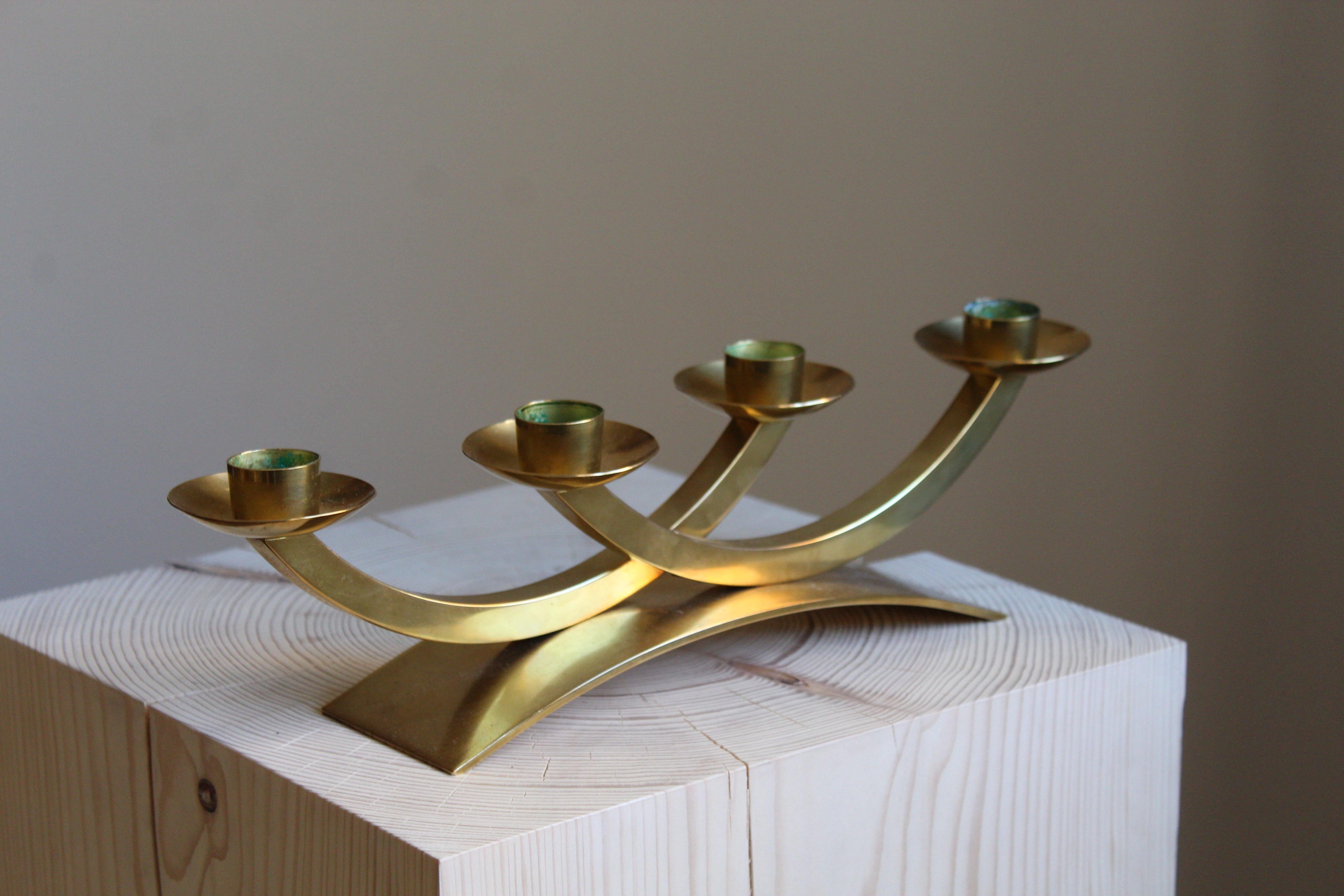 A candelabra, Sweden, 1950s. In brass.

Other designers of the period include Piet Hein, Paavo Tynell, Josef Frank, and Jean Royère.

