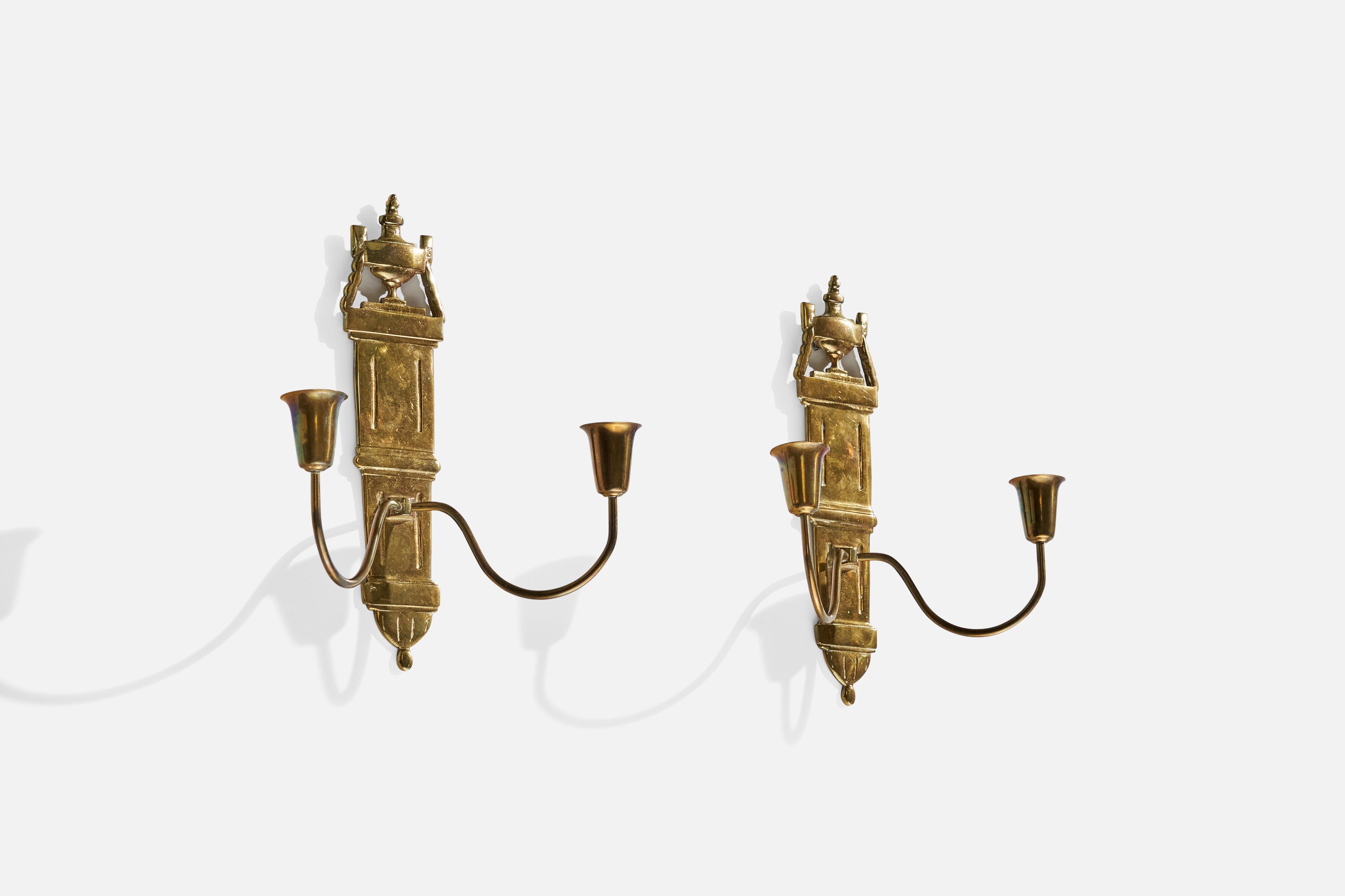 A pair of brass candle sconces designed and produced in Sweden, c. 1940s.

Holds .8” candles.