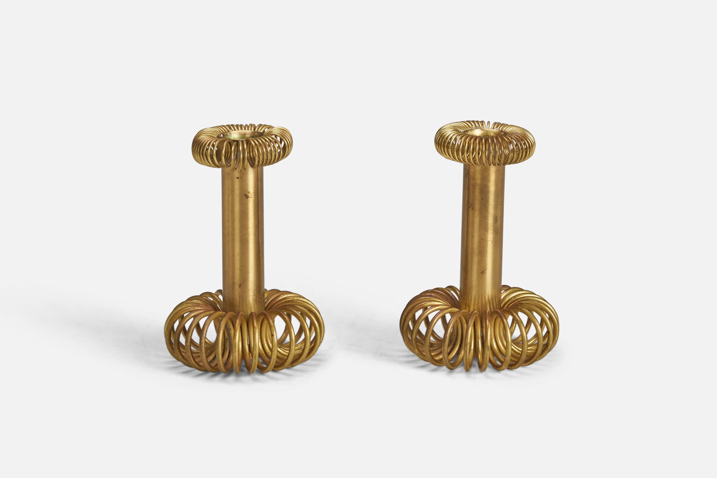 A pair of brass candlesticks designed and produced by a Swedish Designer, Sweden, 1940s.