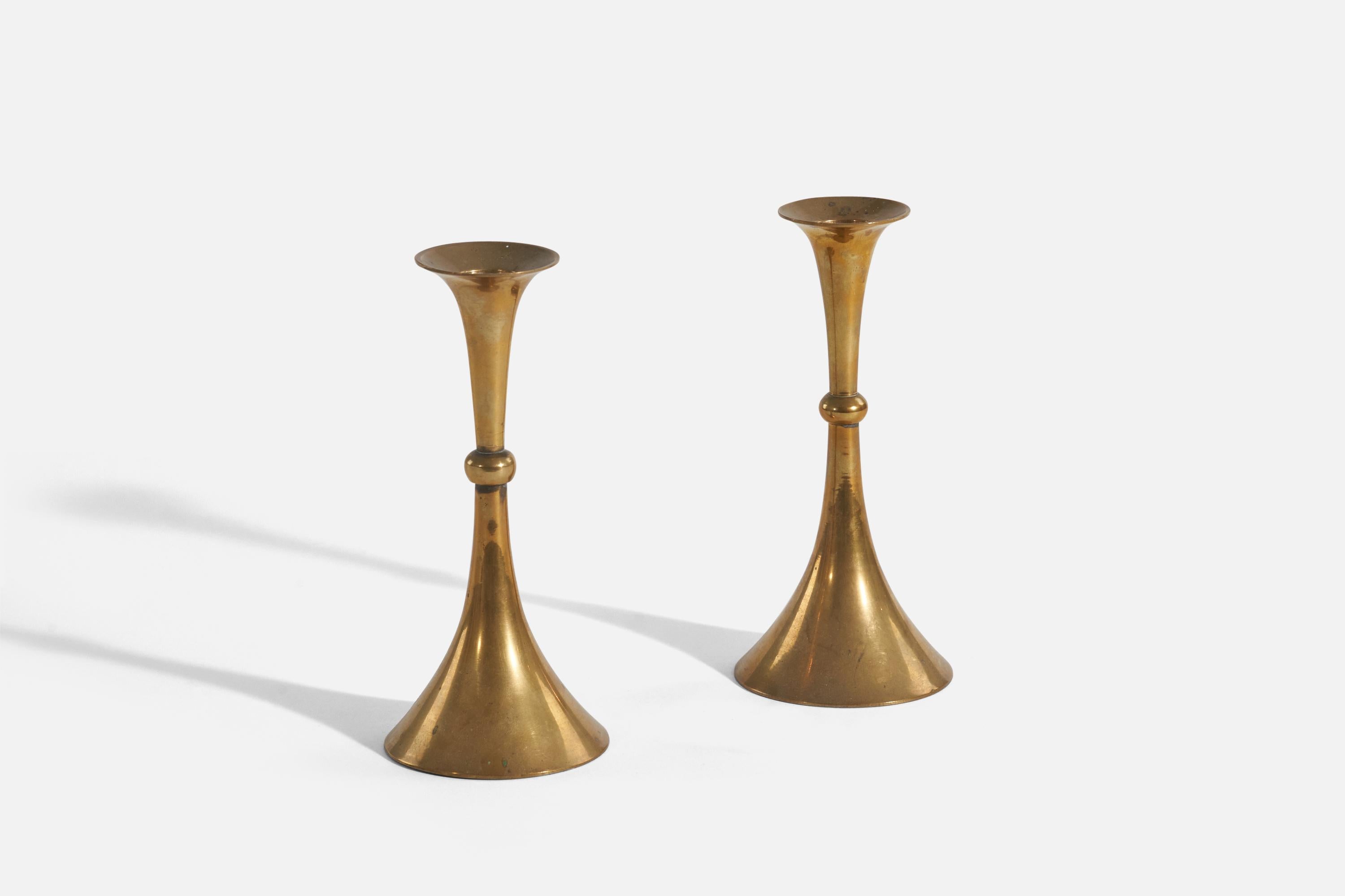 A pair of brass candlesticks designed and produced in Sweden, 1940s.
