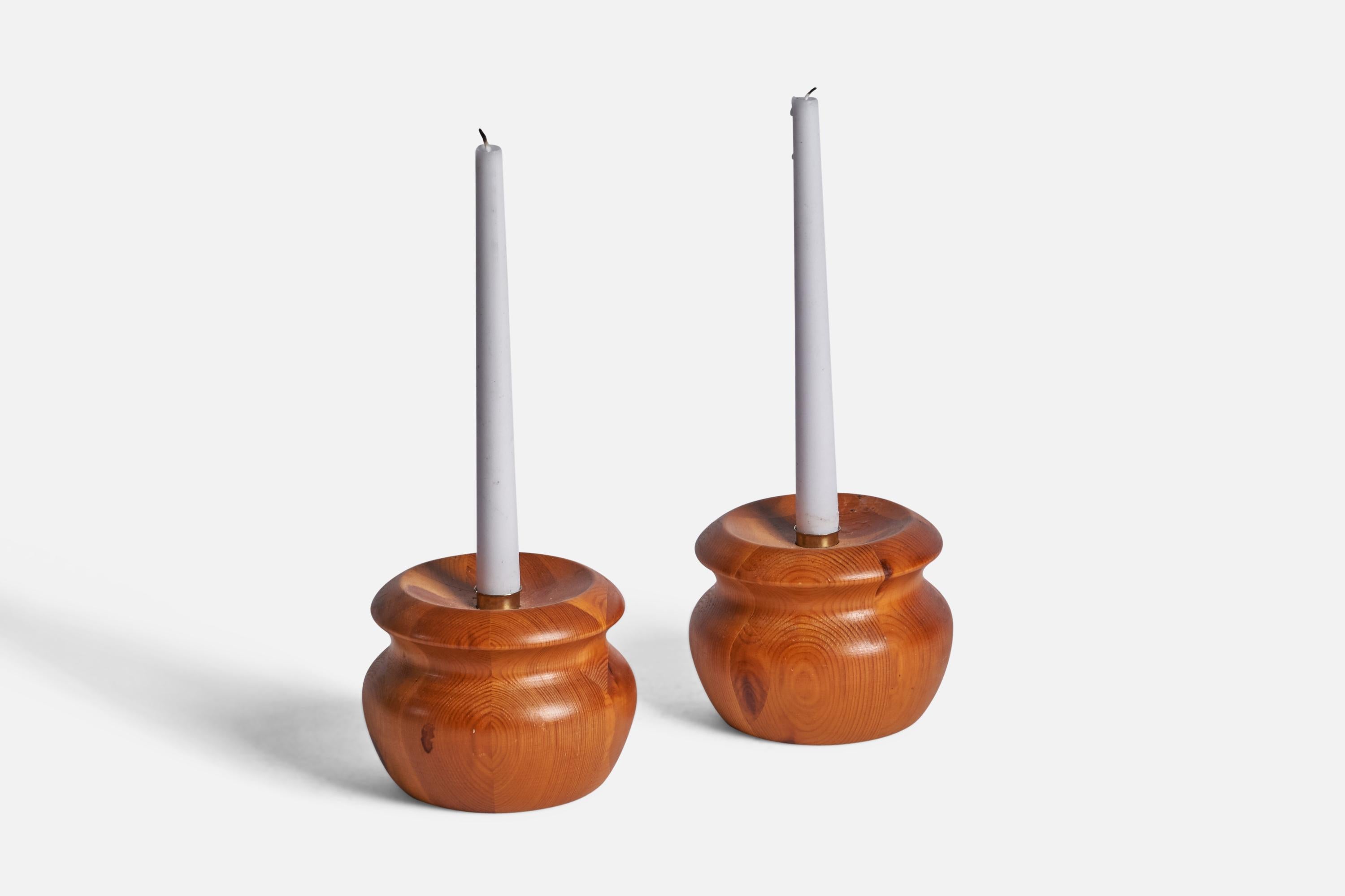 A pair of pine and brass candlesticks designed and produced in Sweden, 1970s.
Holds 0.75” candles