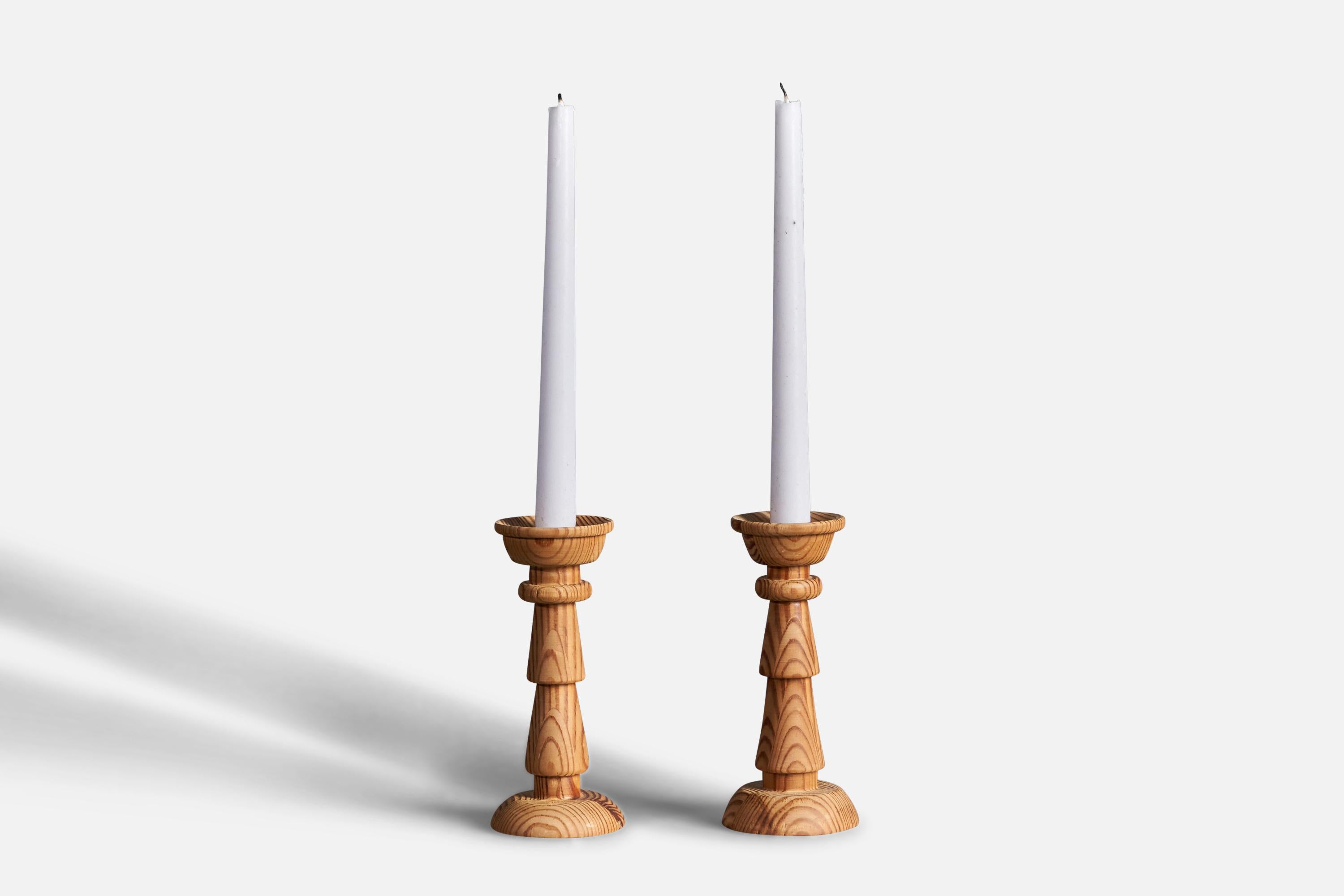 A pair of turned pine candlesticks designed and produced in Sweden, 1970s.