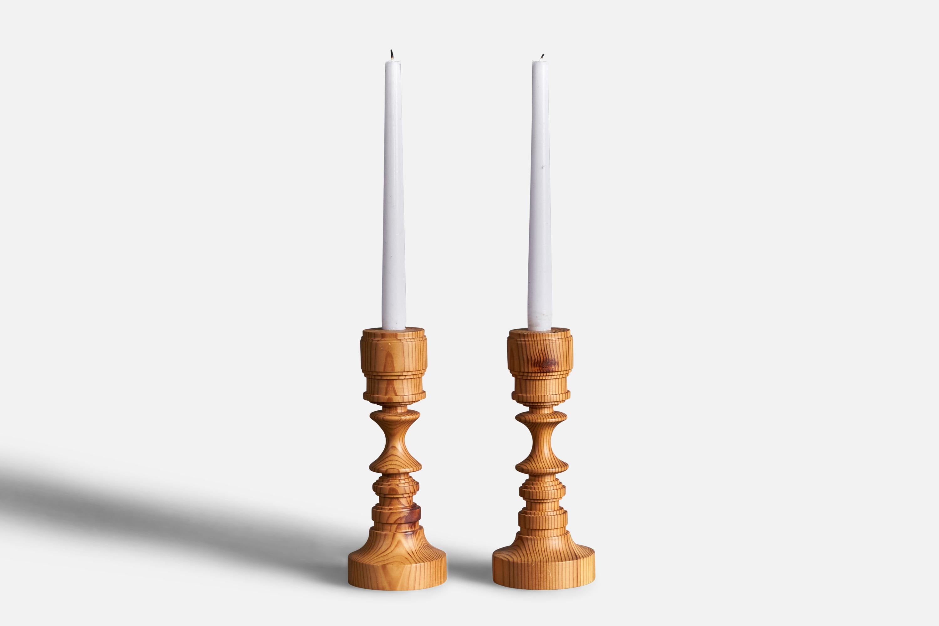 A pair of turned pine candlesticks designed and produced in Sweden, 1970s.