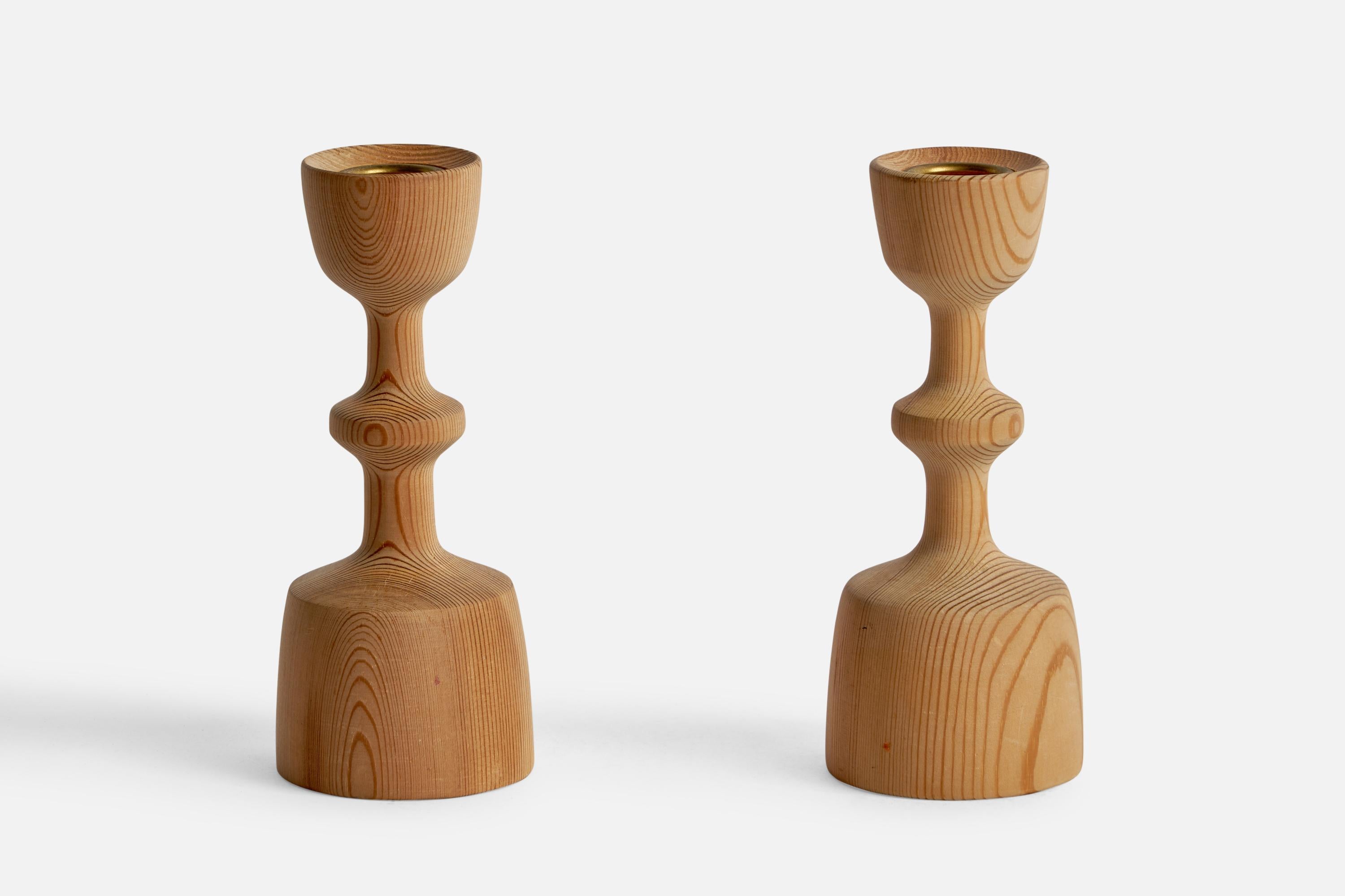 A pair of pine candlesticks designed and produced in Sweden, 1970s.

Holds 0.85” diameter candles