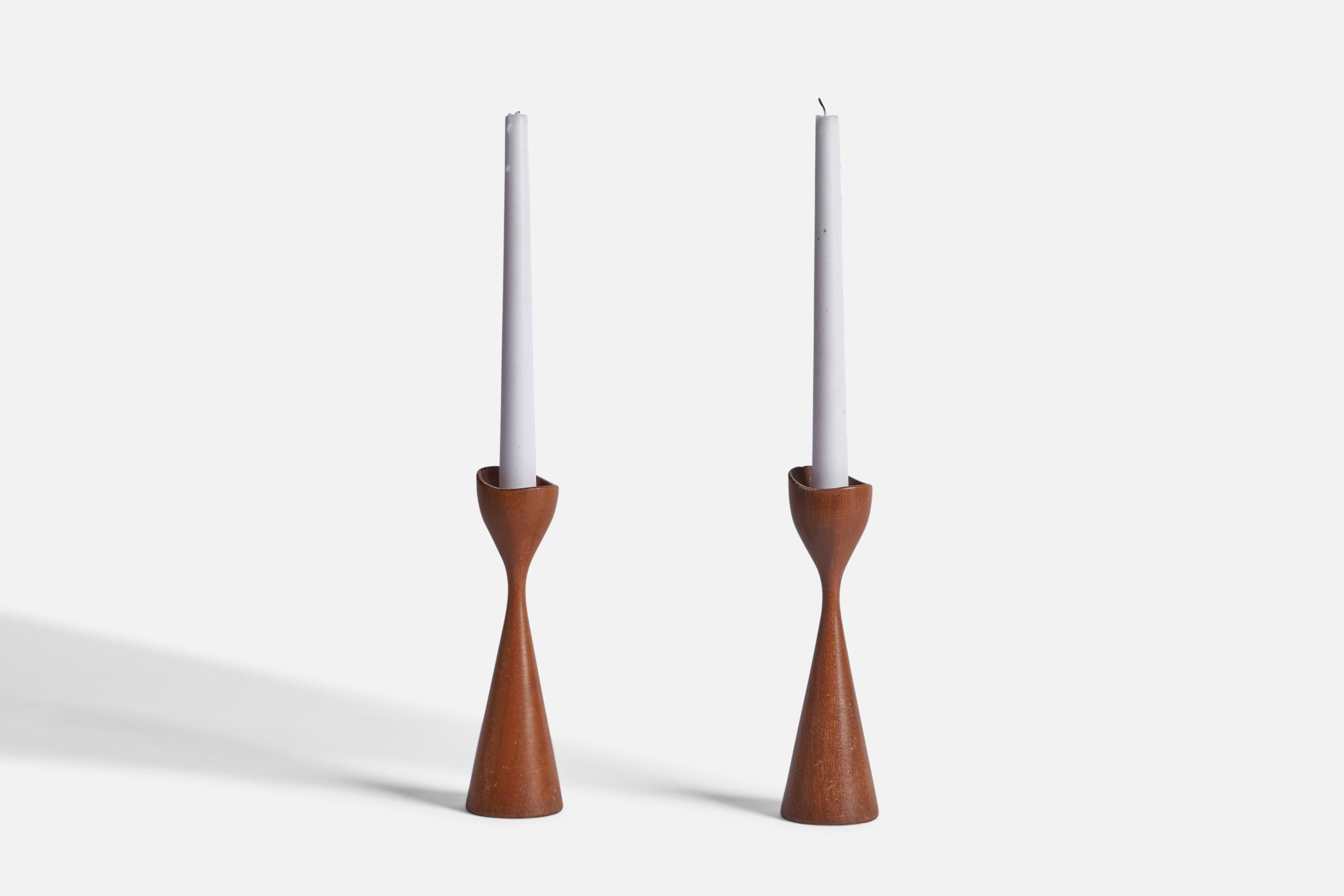 A pair of teak candlesticks designed and produced in Sweden, 1950s.

Candle Diameter (inches): 0.75”