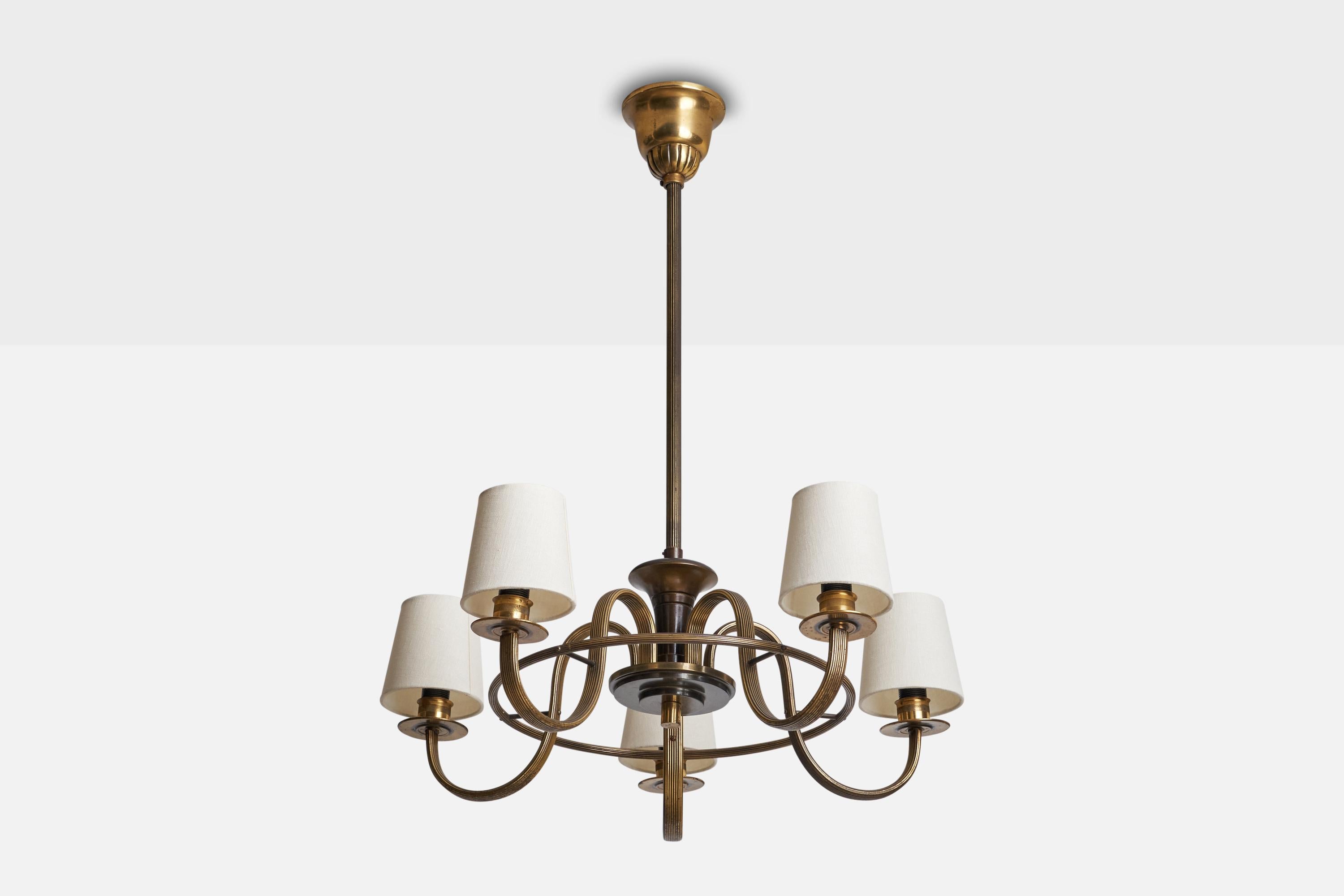 A brass and white fabric chandelier designed and produced in Sweden, c. 1940s.

Dimensions of canopy (inches): 3.50”  H x 4.25” Diameter
Socket takes standard E-12 bulbs. 5 sockets.There is no maximum wattage stated on the fixture. All lighting will