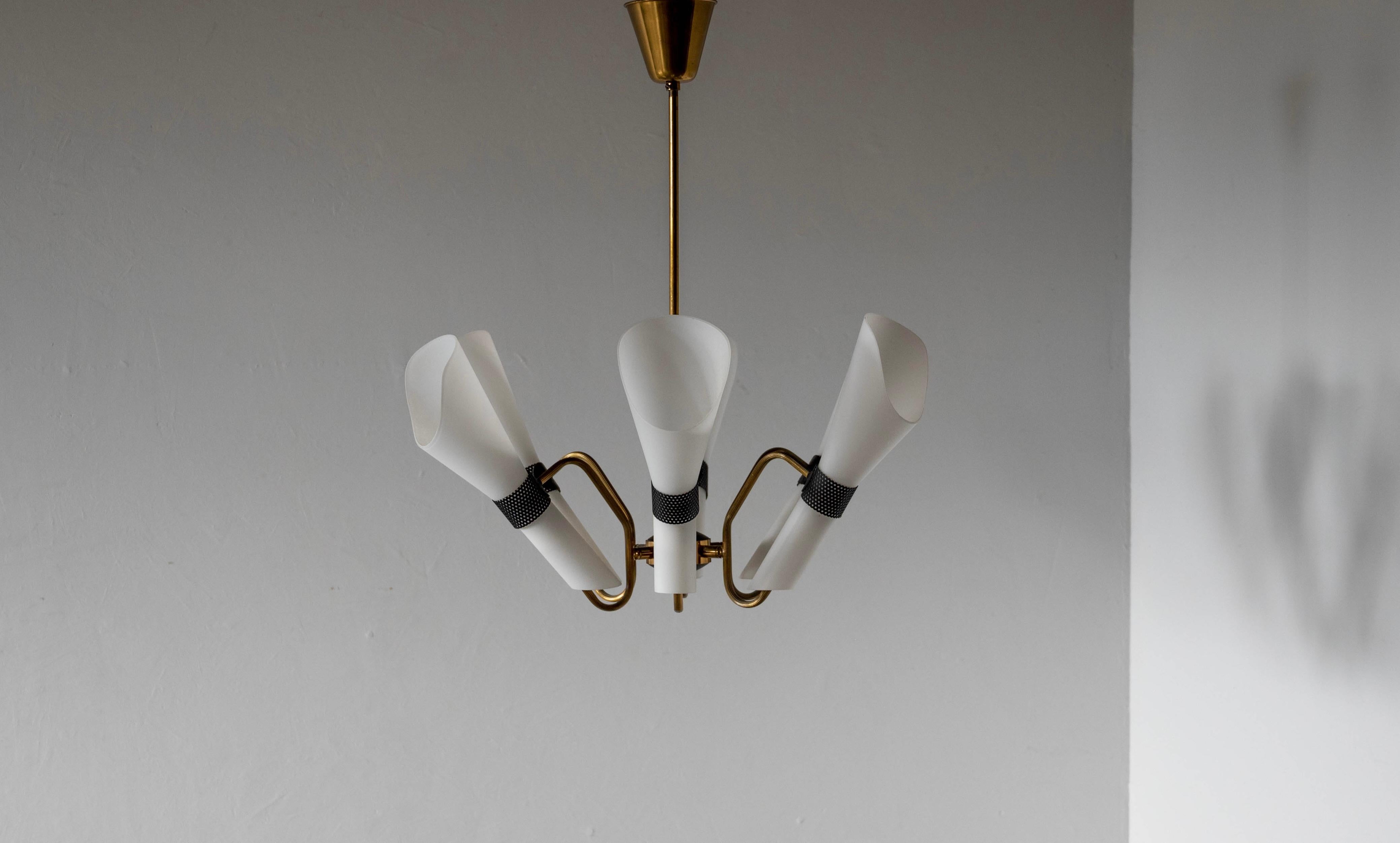 A five-armed chandelier in brass and glass designed and produced by a Swedish designer, Sweden, 1950s.

 