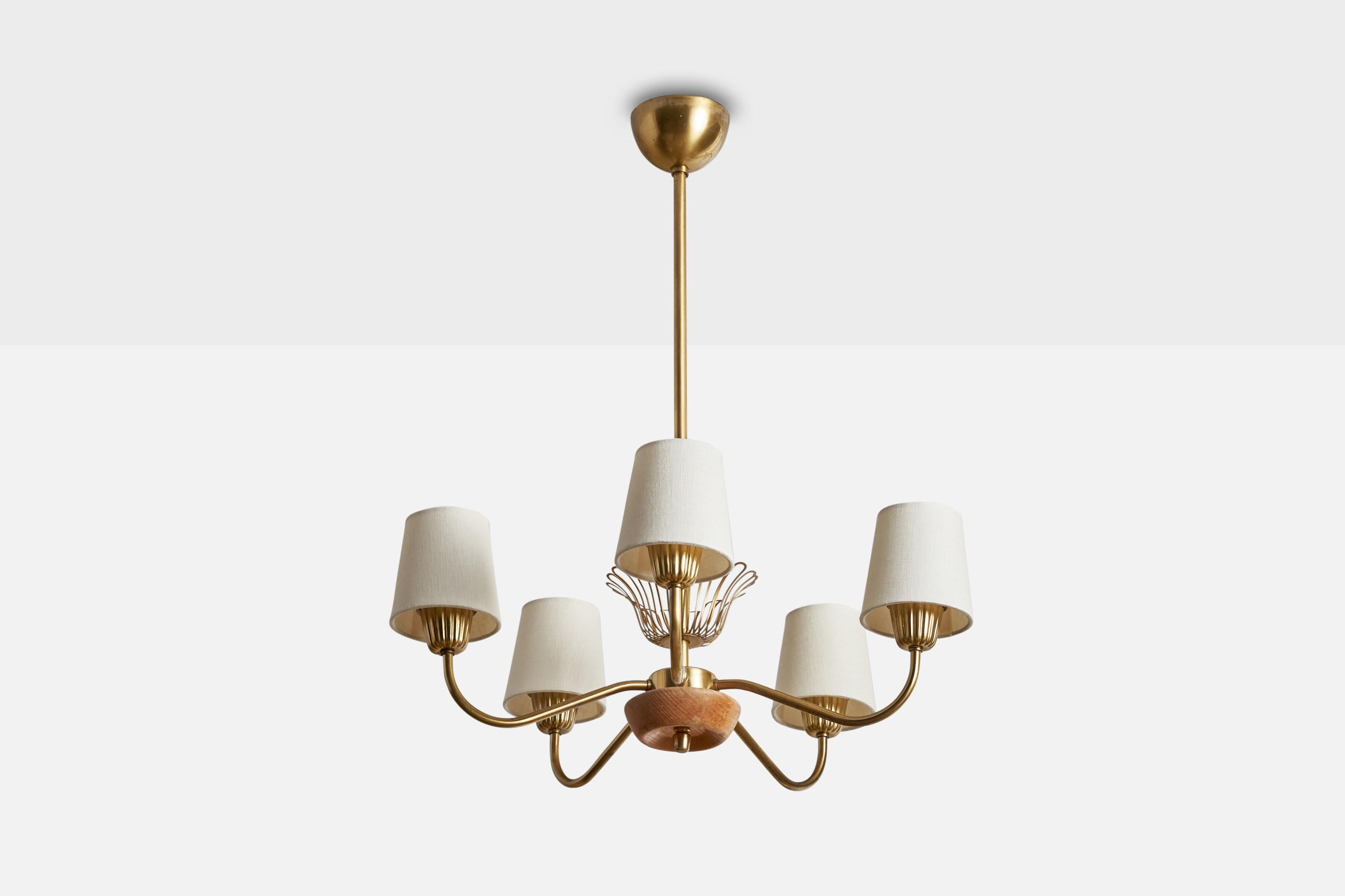 A brass, oak and white fabric chandelier designed and produced in Sweden, 1940s.

Dimensions of canopy (inches): 2.5”  H x 3.5”  Diameter
Socket takes standard E-26 bulbs. 5 sockets.There is no maximum wattage stated on the fixture. All lighting