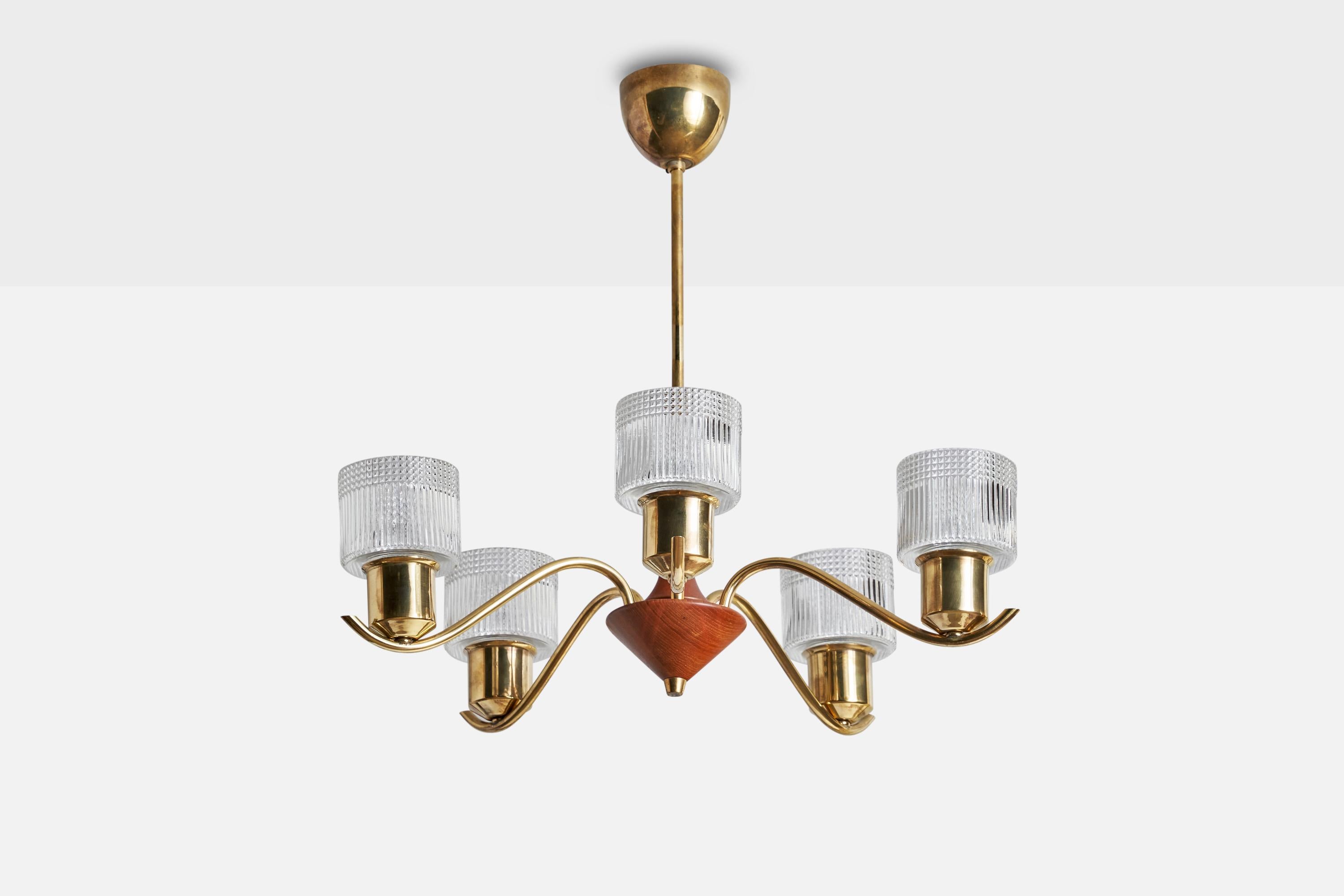 A brass, oak and glass chandelier designed and produced in Sweden, 1950s.

Dimensions of canopy (inches): 2.75” H x 3.25” Diameter
Socket takes standard E-14 bulbs. 5 sockets.There is no maximum wattage stated on the fixture. All lighting will be
