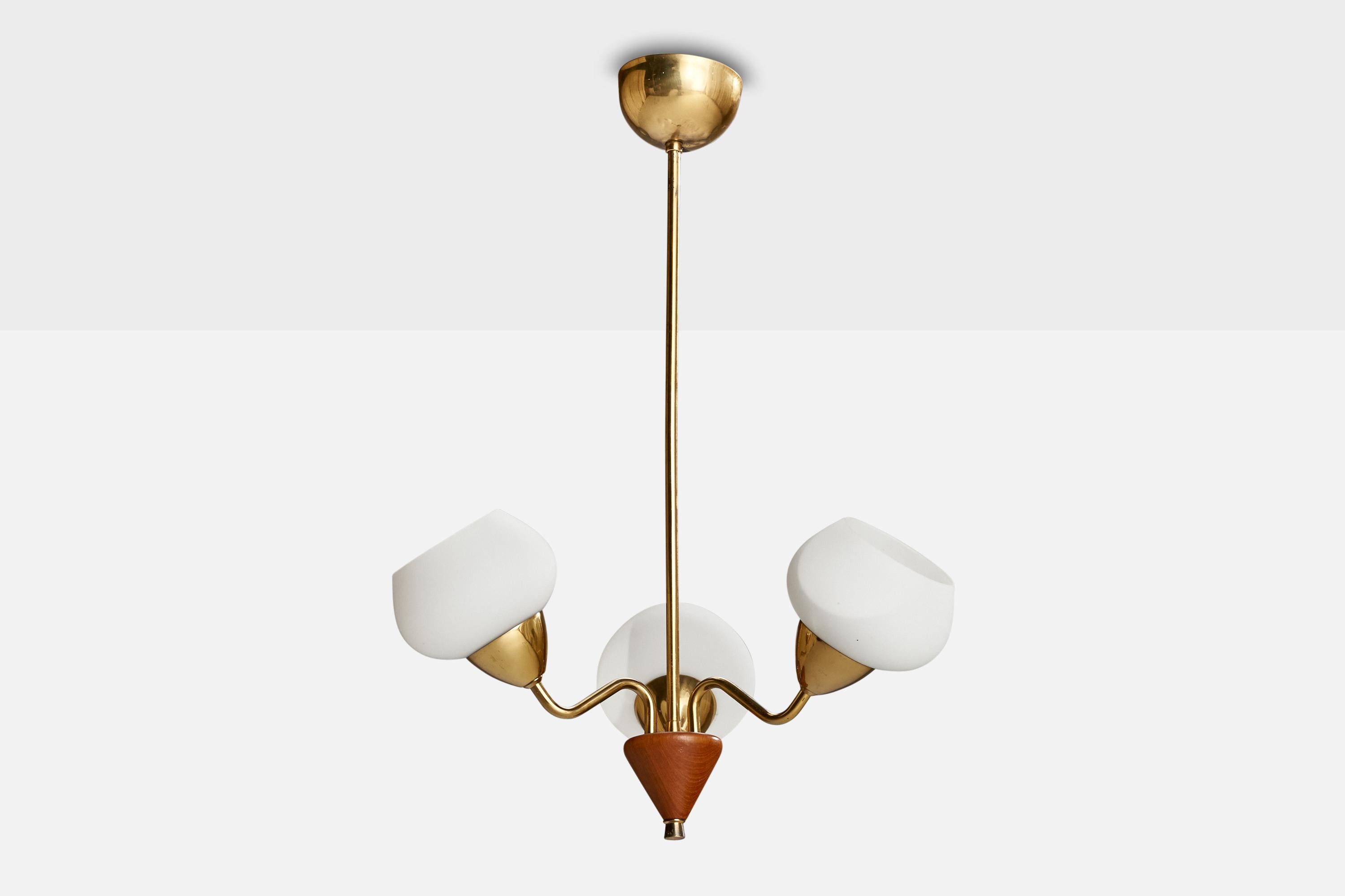A brass, oak and opaline glass chandelier designed and produced in Sweden, c. 1950s.

Dimensions of canopy (inches): 2.40” H x 3.88” Diameter
Socket takes standard E-26 bulbs. 3 socket.There is no maximum wattage stated on the fixture. All lighting