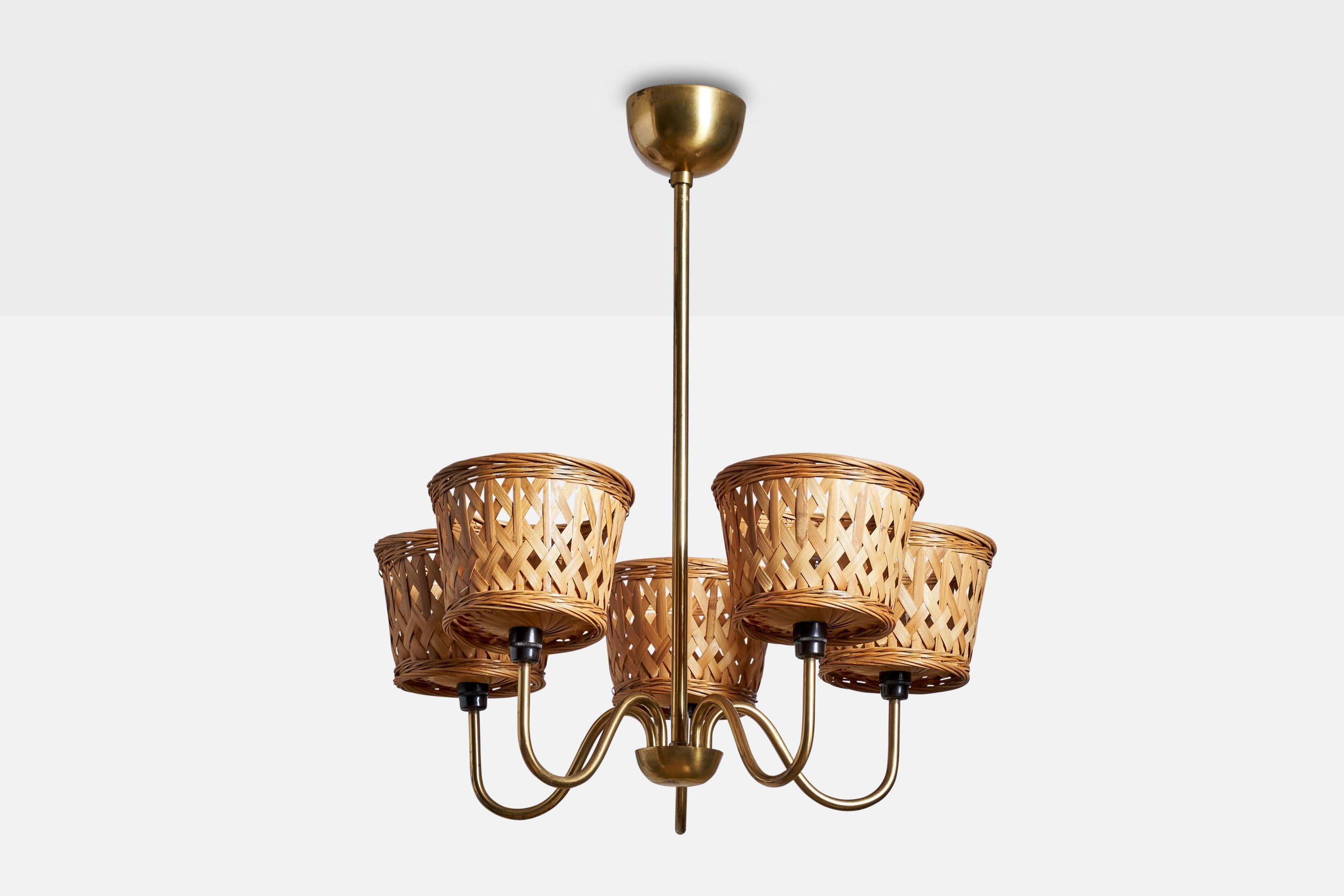 A brass and rattan chandelier designed and produced in Sweden, 1950s.

Dimensions of canopy (inches): 2.5” H x 3.5”  Diameter
Socket takes standard E-14 bulbs. 5 sockets.There is no maximum wattage stated on the fixture. All lighting will be