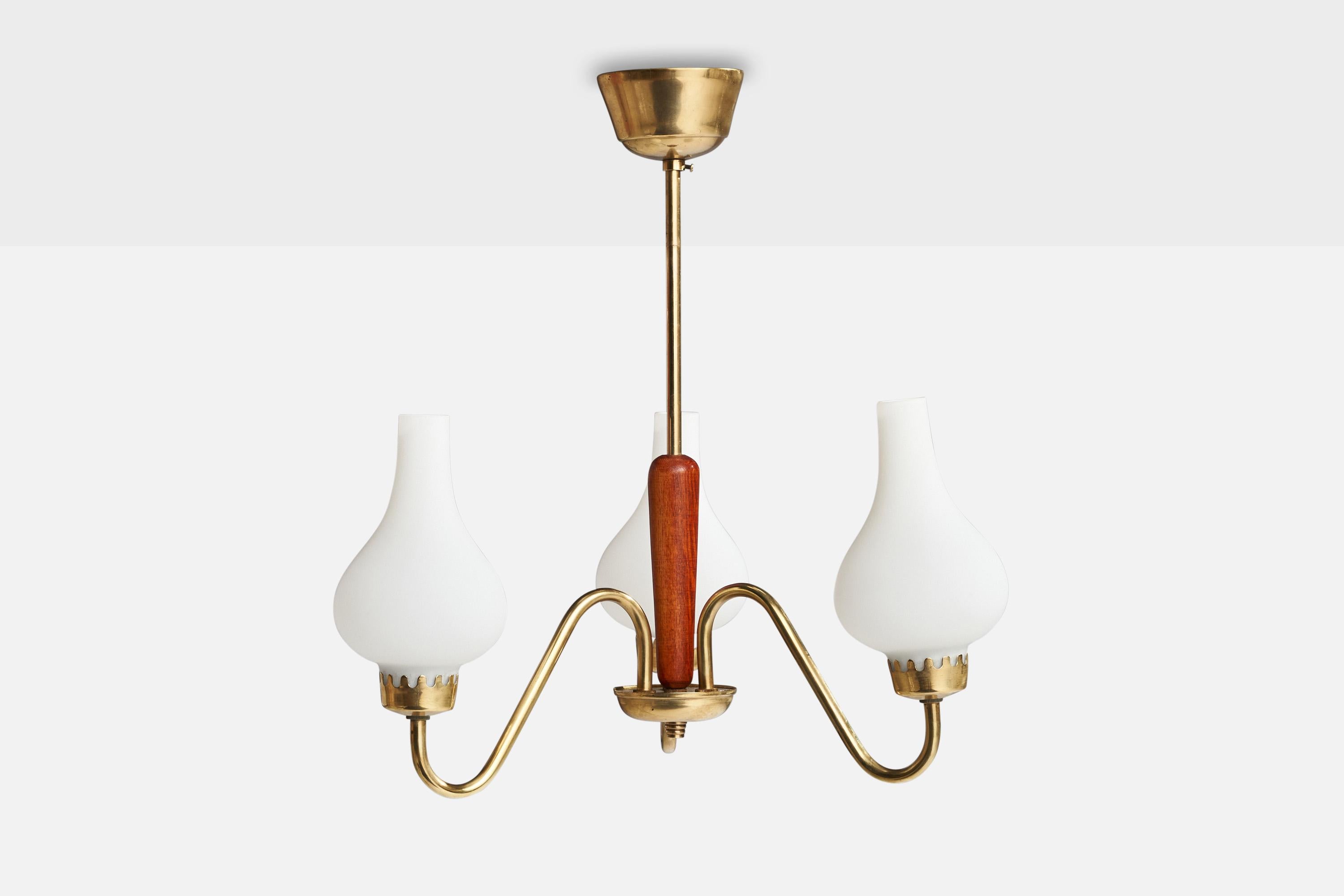 A brass, teak and opaline glass chandelier designed and produced in Sweden, 1950s.

Dimensions of canopy (inches): 2” H x 3.5” Diameter
Socket takes standard E-14 bulbs. 3 sockets.There is no maximum wattage stated on the fixture. All lighting will