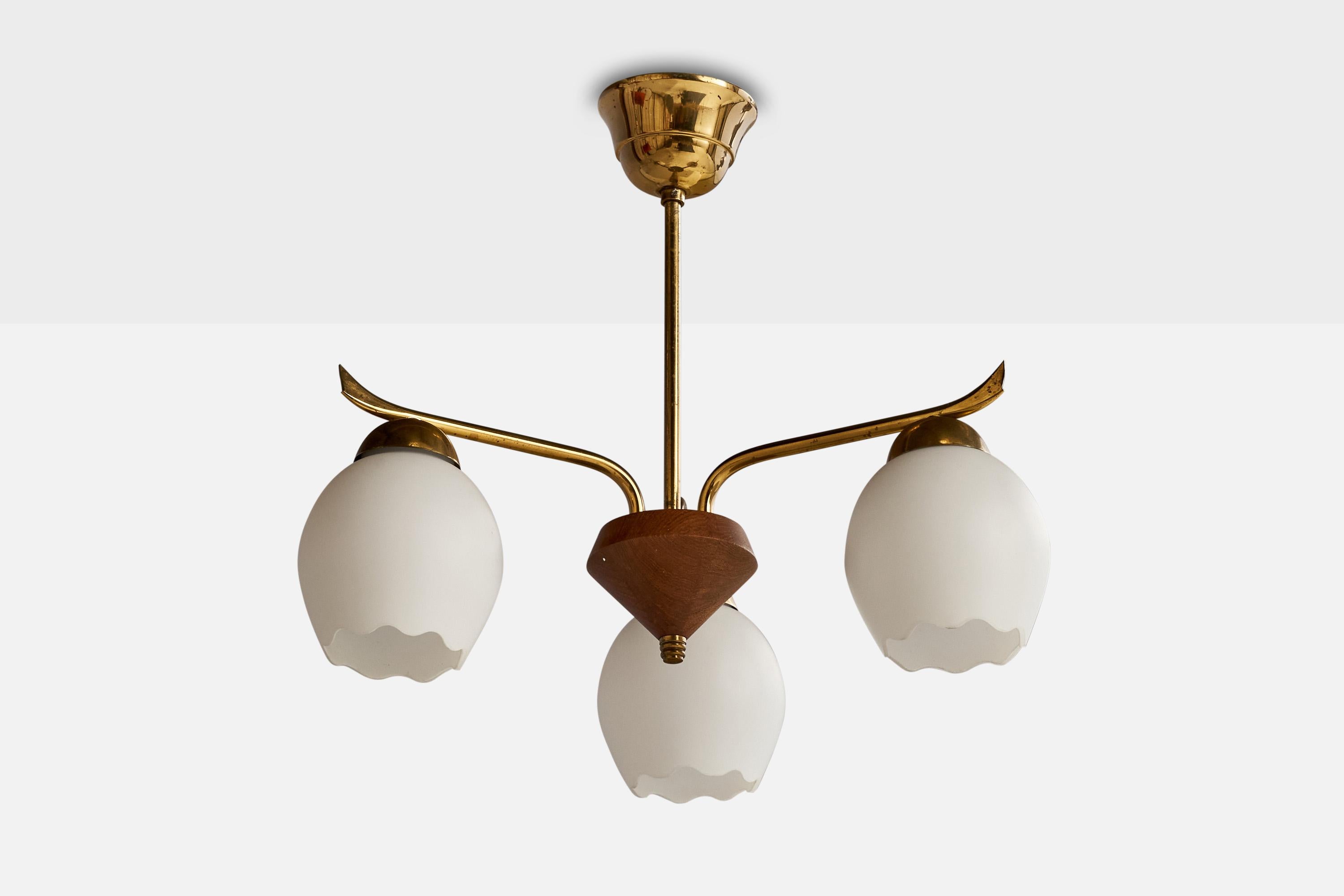 A brass teak and glass chandelier light designed and produced in Sweden, 1950s.

Dimensions of canopy (inches): 2.5” H x 3.75”  Diameter
Socket takes standard E-26 bulbs. 3 sockets.There is no maximum wattage stated on the fixture. All lighting will