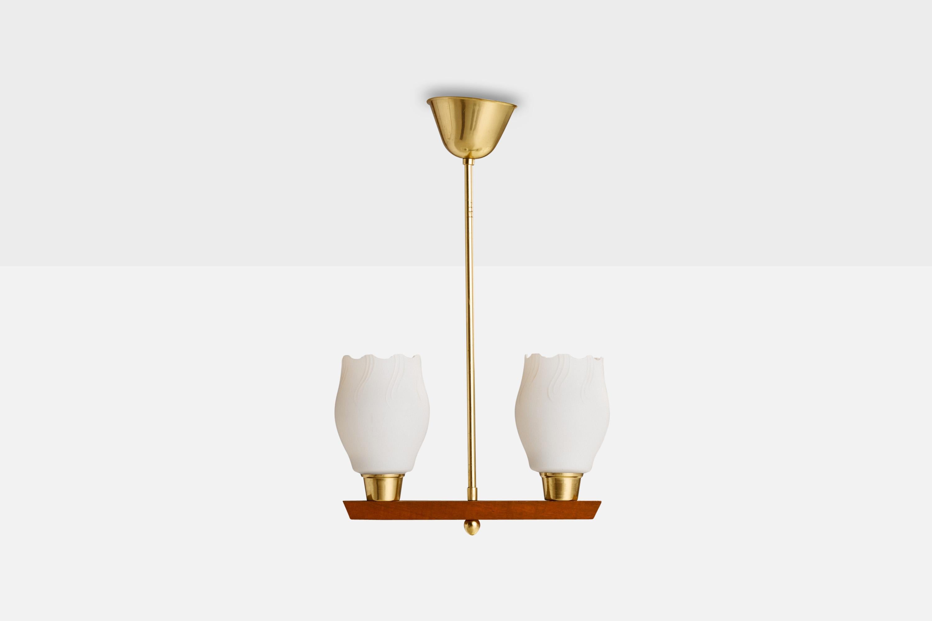 A brass, teak and glass pendant light designed and produced in Sweden, 1950s.

Dimensions of canopy (inches): 2.75” H x 4.25”  Diameter
Socket takes standard E-26 bulbs. 2 sockets.There is no maximum wattage stated on the fixture. All lighting will