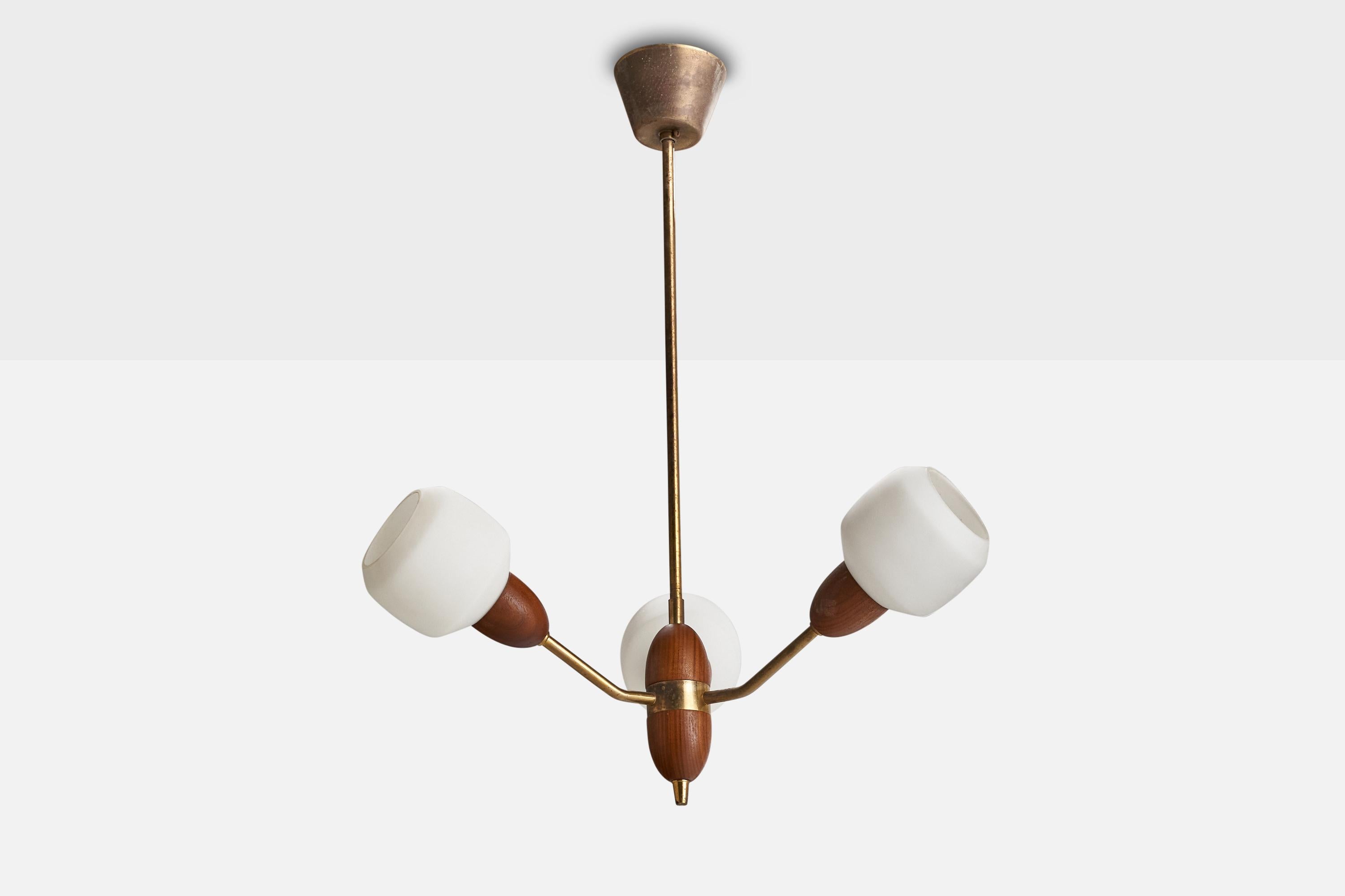 A brass, teak and opaline glass chandelier designed and produced in Sweden, c. 1950s.

Dimensions of canopy (inches): 2.67” H x 3.54” Diameter
Socket takes standard E-14 bulbs. 3 socket.There is no maximum wattage stated on the fixture. All lighting