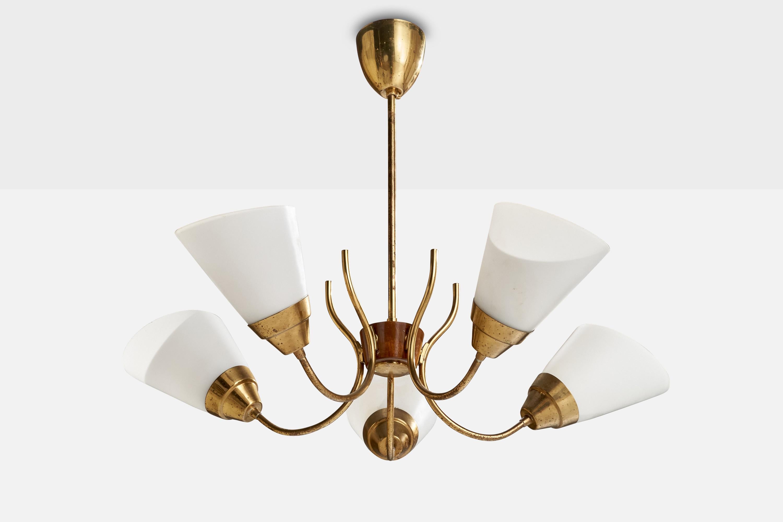 A brass, teak and opaline glass chandelier designed and produced in Sweden, c. 1950s.

Dimensions of canopy (inches): 3.45” H x 3.38” Diameter
Socket takes standard E-26 bulbs. 5 socket.There is no maximum wattage stated on the fixture. All lighting