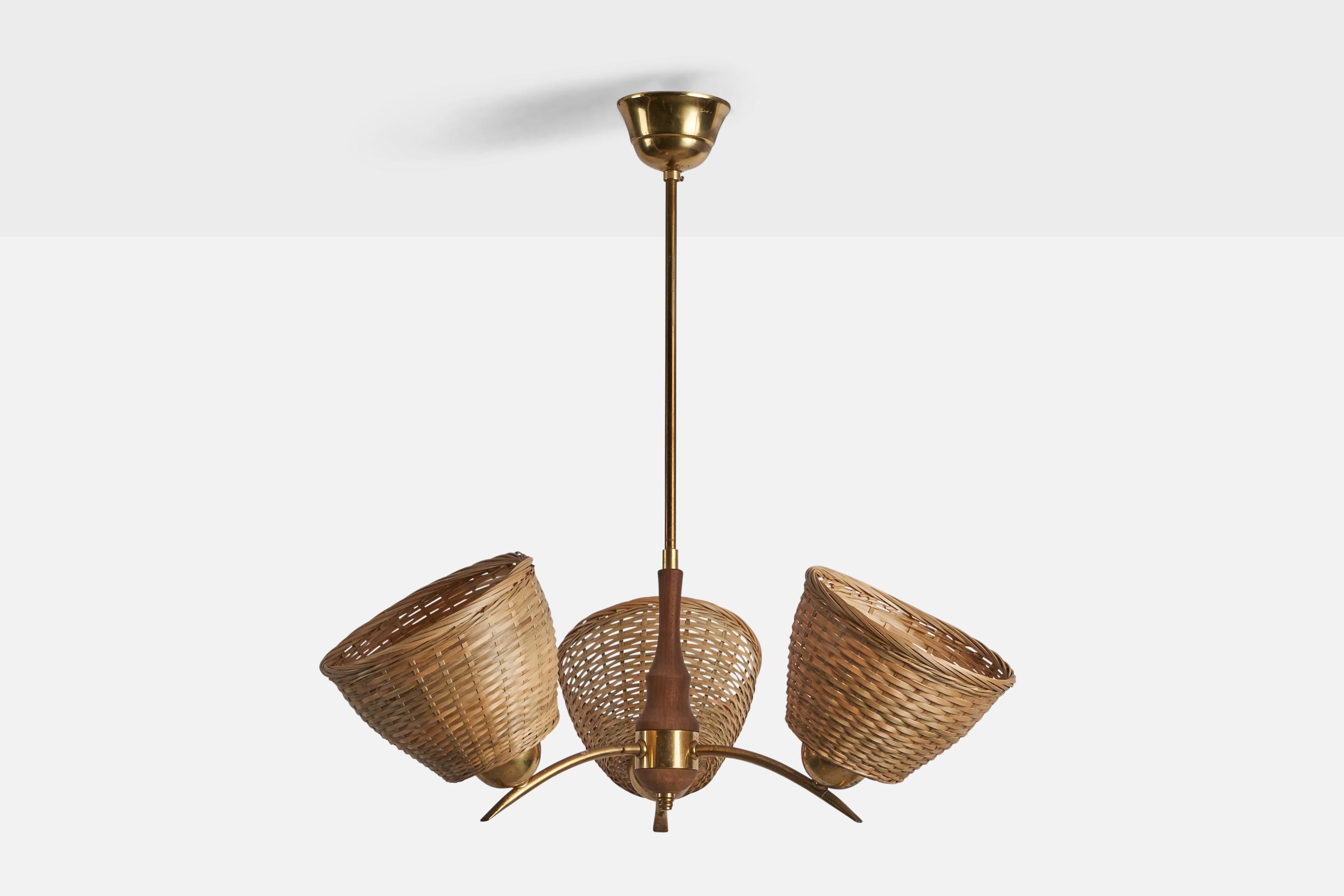 A three-armed brass teak and rattan chandelier designed and produced in Sweden, c. 1950s.

