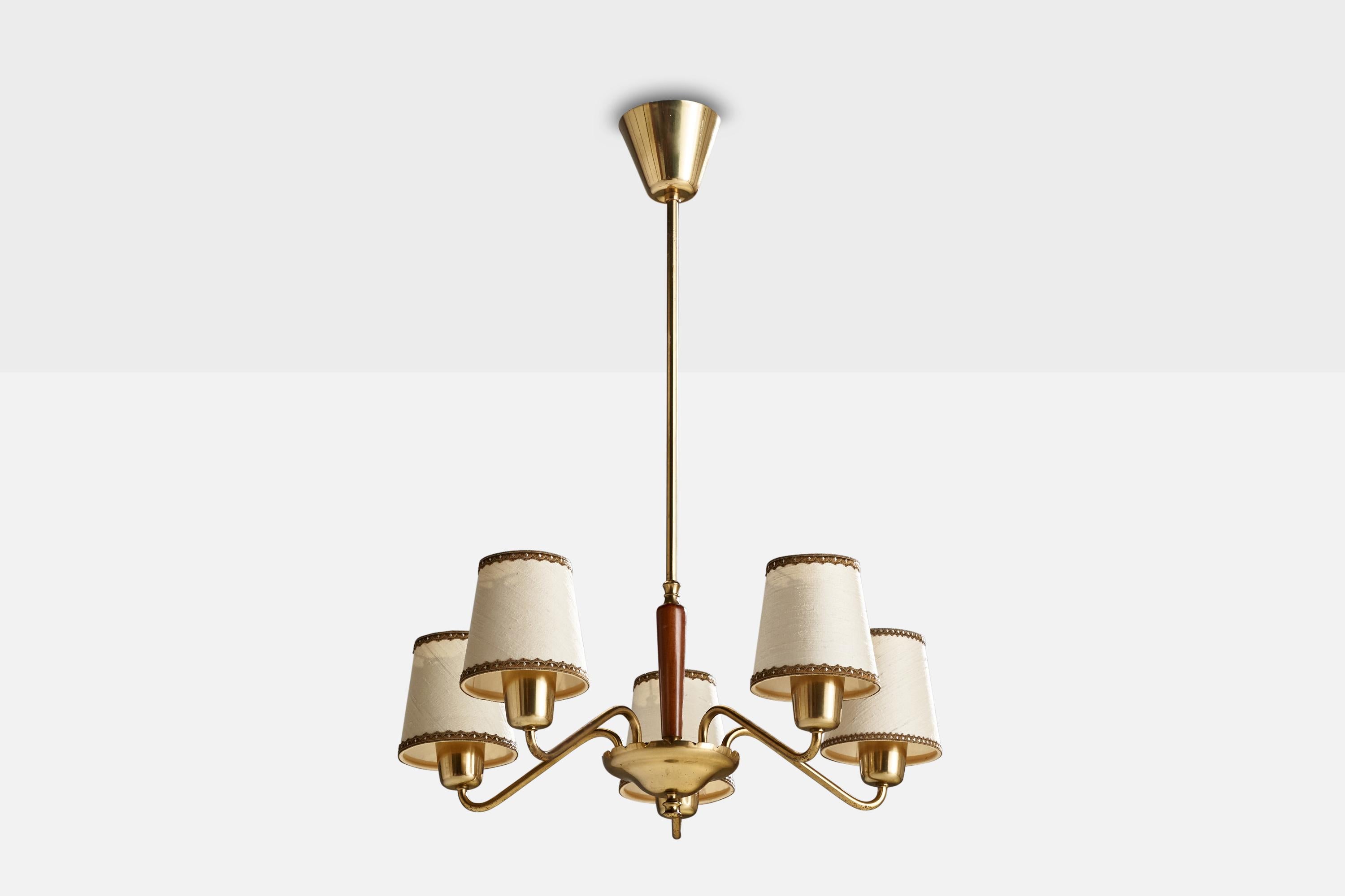 A brass, stained wood and off-white fabric chandelier designed and produced in Sweden, 1940s.

Dimensions of canopy (inches): 3.09” H x 3.54” Diameter
Socket takes standard E-26 bulbs. 5 socket.There is no maximum wattage stated on the fixture. All