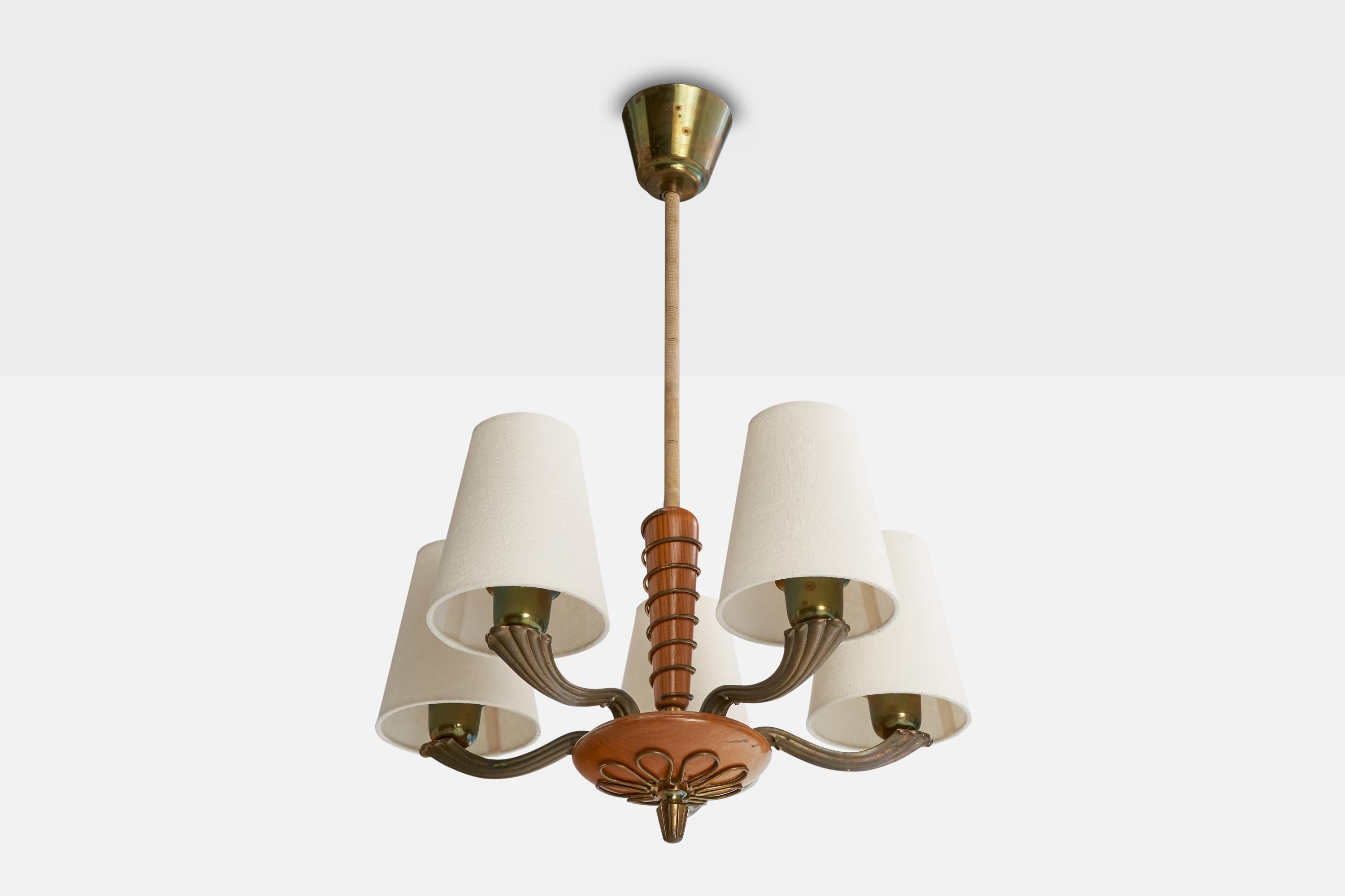 A brass, wood, and white fabric chandelier designed and produced in Sweden, c. 1940s.

Overall Dimensions (inches): 29” H x  17” Diameter

Dimensions of Canopy:  3.25” H x 3.75” diameter

Stem length: 15” H

Bulb Specifications: E-26 candle

Number
