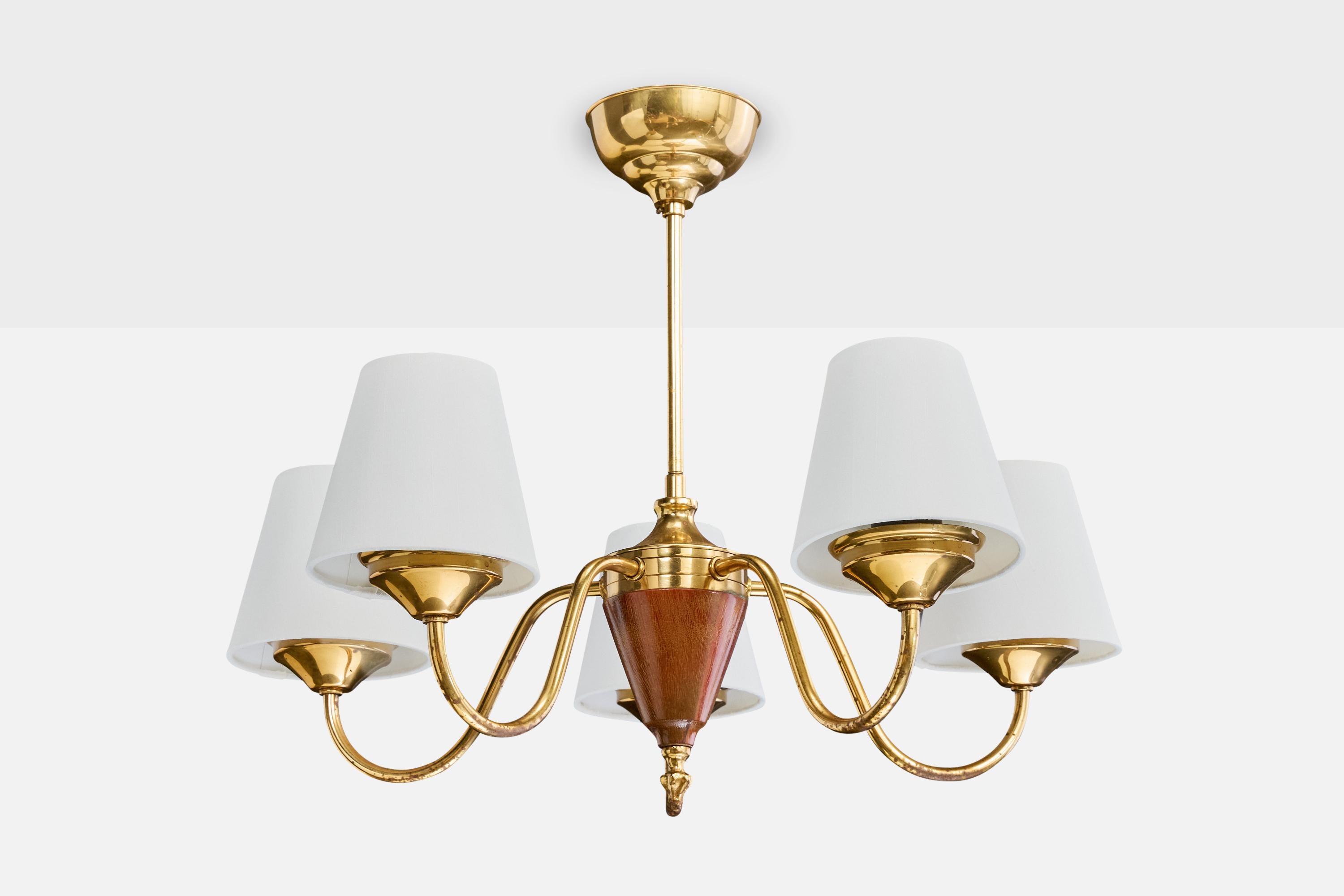 A brass and wood chandelier designed and produced in Sweden, c. 1950s.

The brass arms present with moderate oxidation.

Overall Dimensions (inches): 18.0