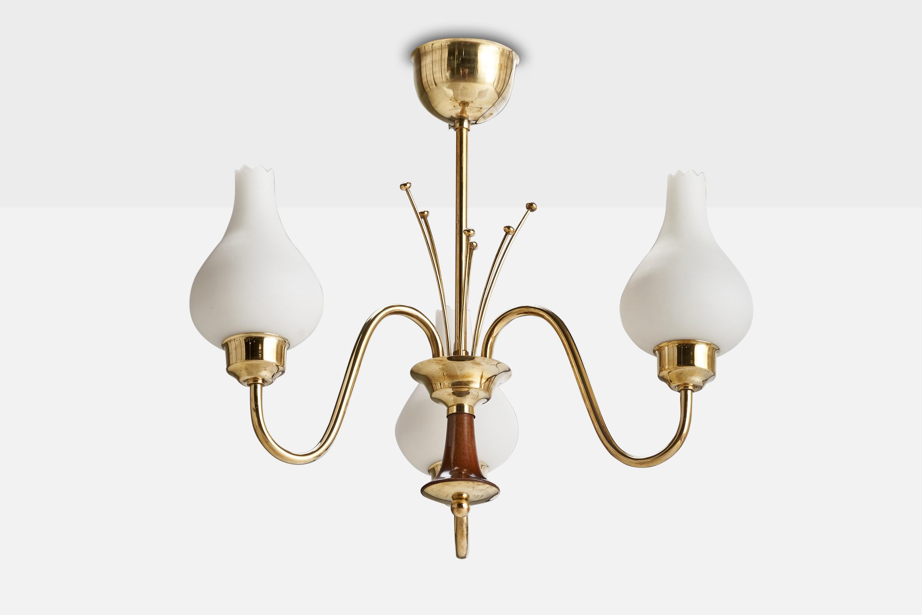 A brass, wood and opaline glass chandelier designed and produced in Sweden, 1950s.

Dimensions of canopy (inches): 3.54” H x 2.5” Diameter
Socket takes standard E-14 bulbs. 3 socket.There is no maximum wattage stated on the fixture. All lighting