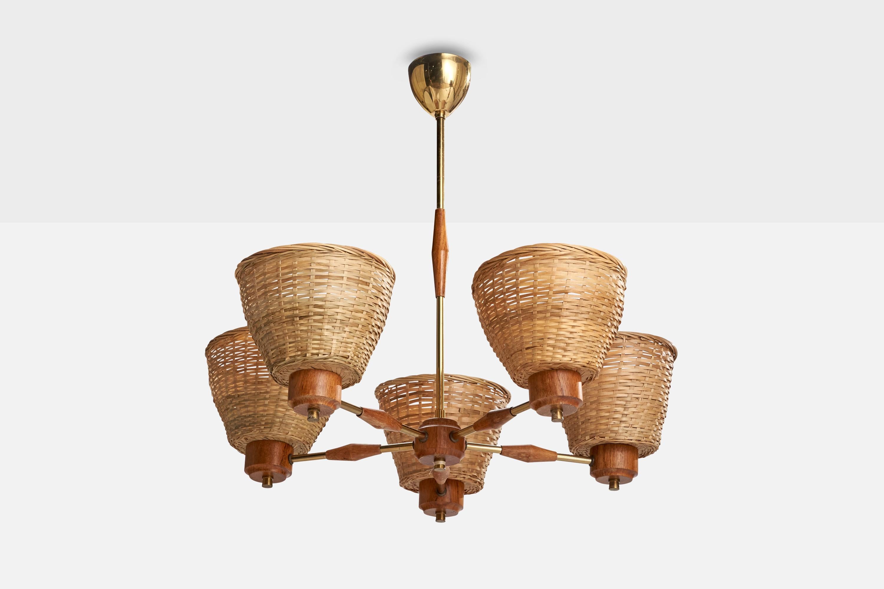 A teak, brass and rattan chandelier designed and produced in Sweden, c. 1950s.

Dimensions of canopy (inches): 2.79” H x 3.08” Diameter
Socket takes standard E-26 bulbs. 5 socket.There is no maximum wattage stated on the fixture. All lighting will