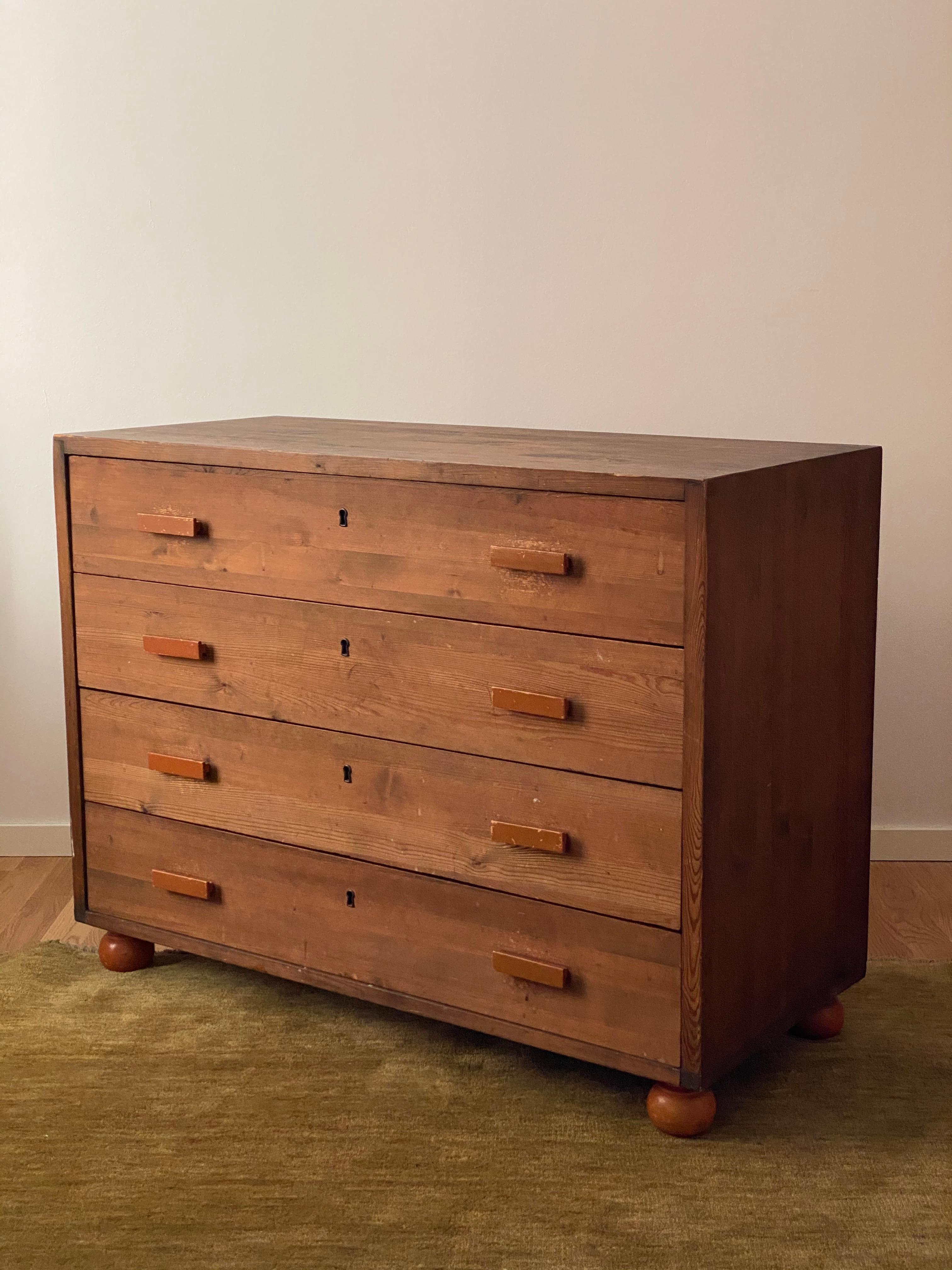 A highly functionalist chest of drawers in stained pine. Features beautifully contrasting pulls and round legs in stained beech. Designed by an unknown Swedish designer, 1940s. 

Other designers of the period include Axel Einar Hjorth, Alvar