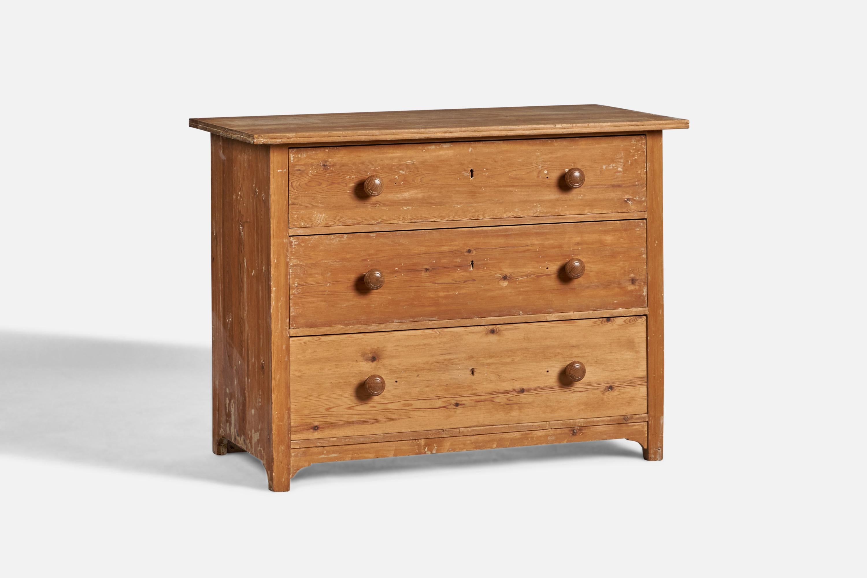 A pine chest of drawers designed and produced in Sweden c. 1900.
