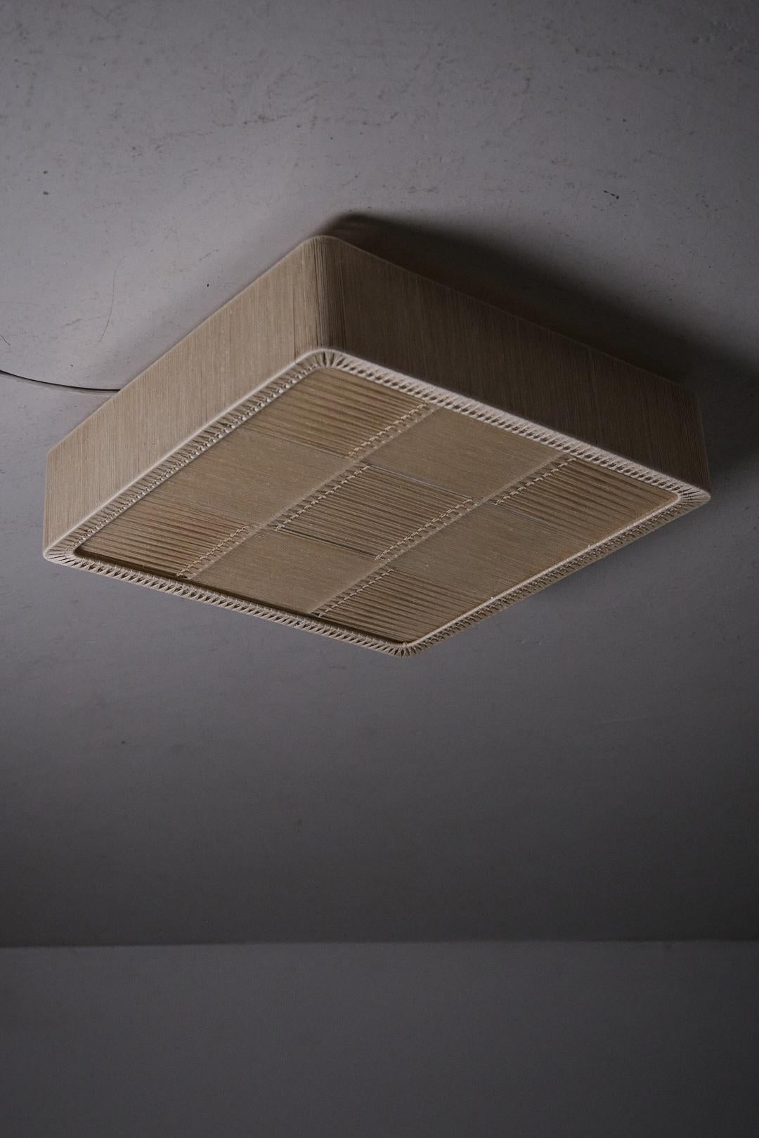 Flush mount made by unknown designer in Sweden during the 1960s.

Beige fabric chord on a steel frame.