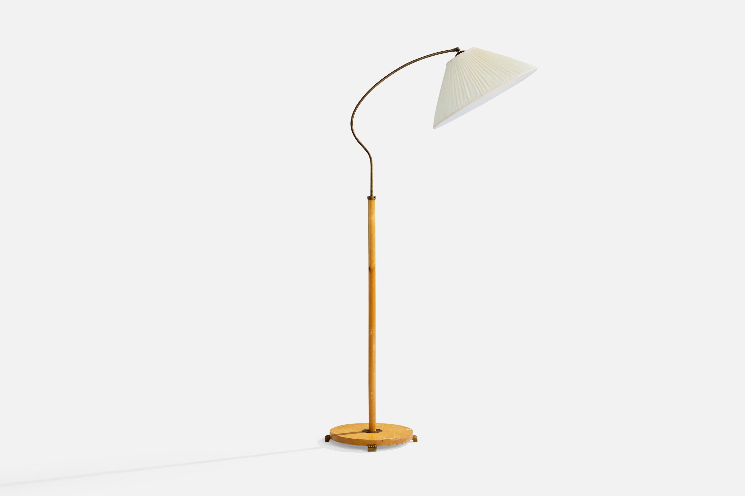A brass, birch and fabric floor lamp designed and produced in Sweden, c. 1940s.

Light scratching to wood stand and light oxidation to brass neck.

Dimensions of Lamp with Shade (inches): 61.5
