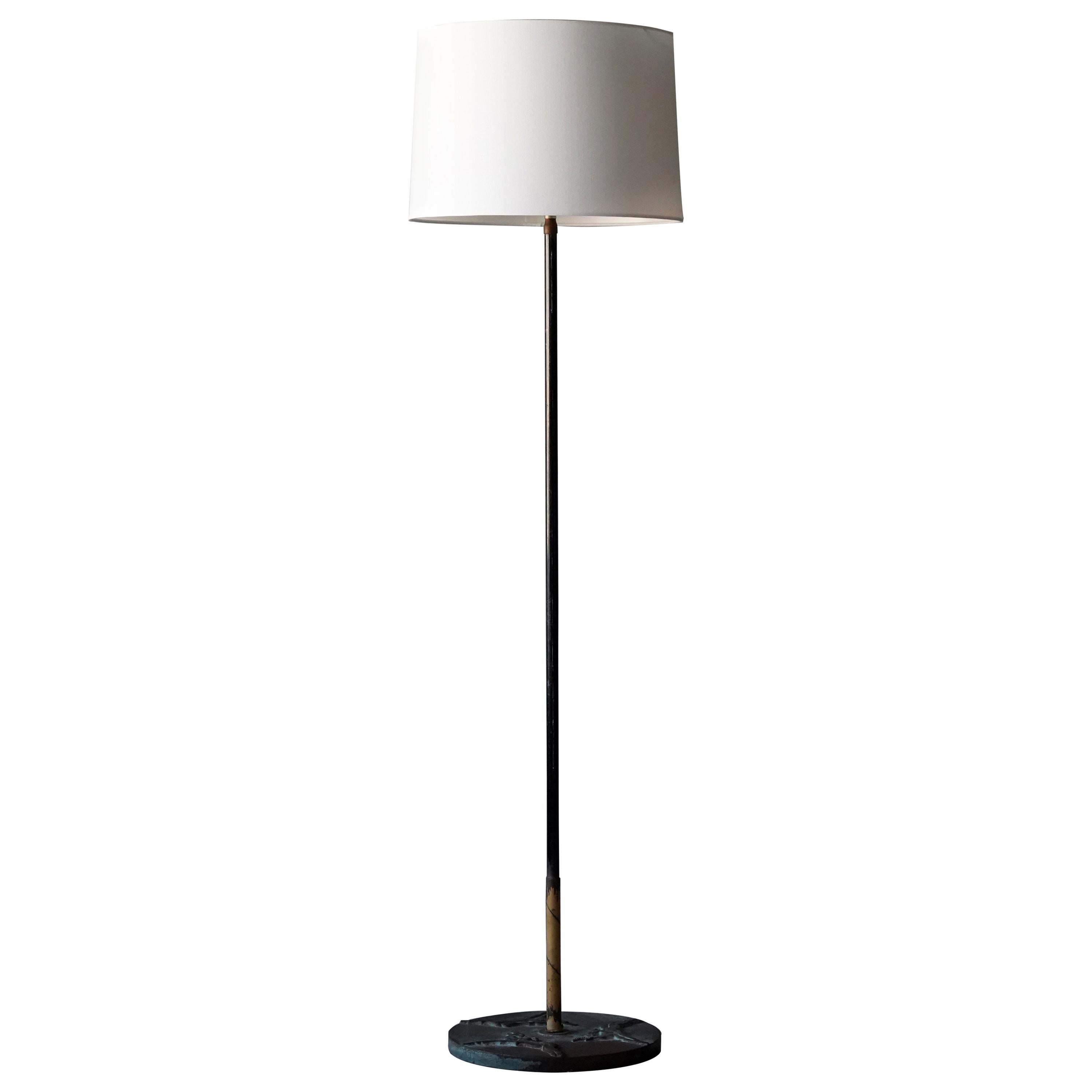 A Swedish floor lamp. Designed and produced in the 1940s. Features painted tubular steel, base in cast bronze featuring highly stylized motifs.

Lampshade is not included in purchase. Stated dimensions exclude lampshade.

Other designers of the