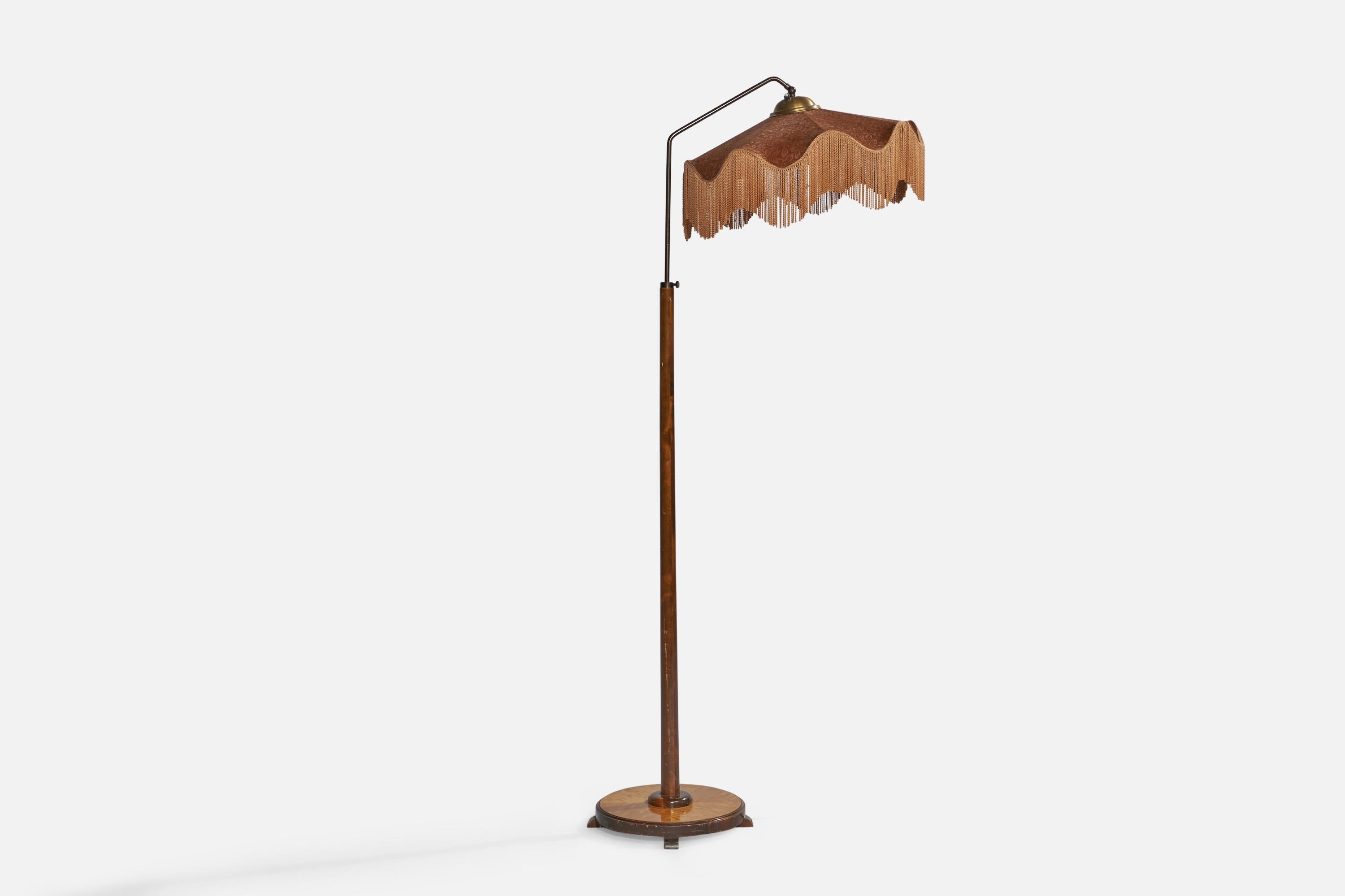 An adjustable brass, birch and fabric floor lamp designed and produced in Sweden, c. 1930s.

Overall Dimensions (inches): 65” H x 29” W x 21” D. Stated dimensions include shade.
Bulb Specifications: E-26 Bulb
Number of Sockets: 1
All lighting will