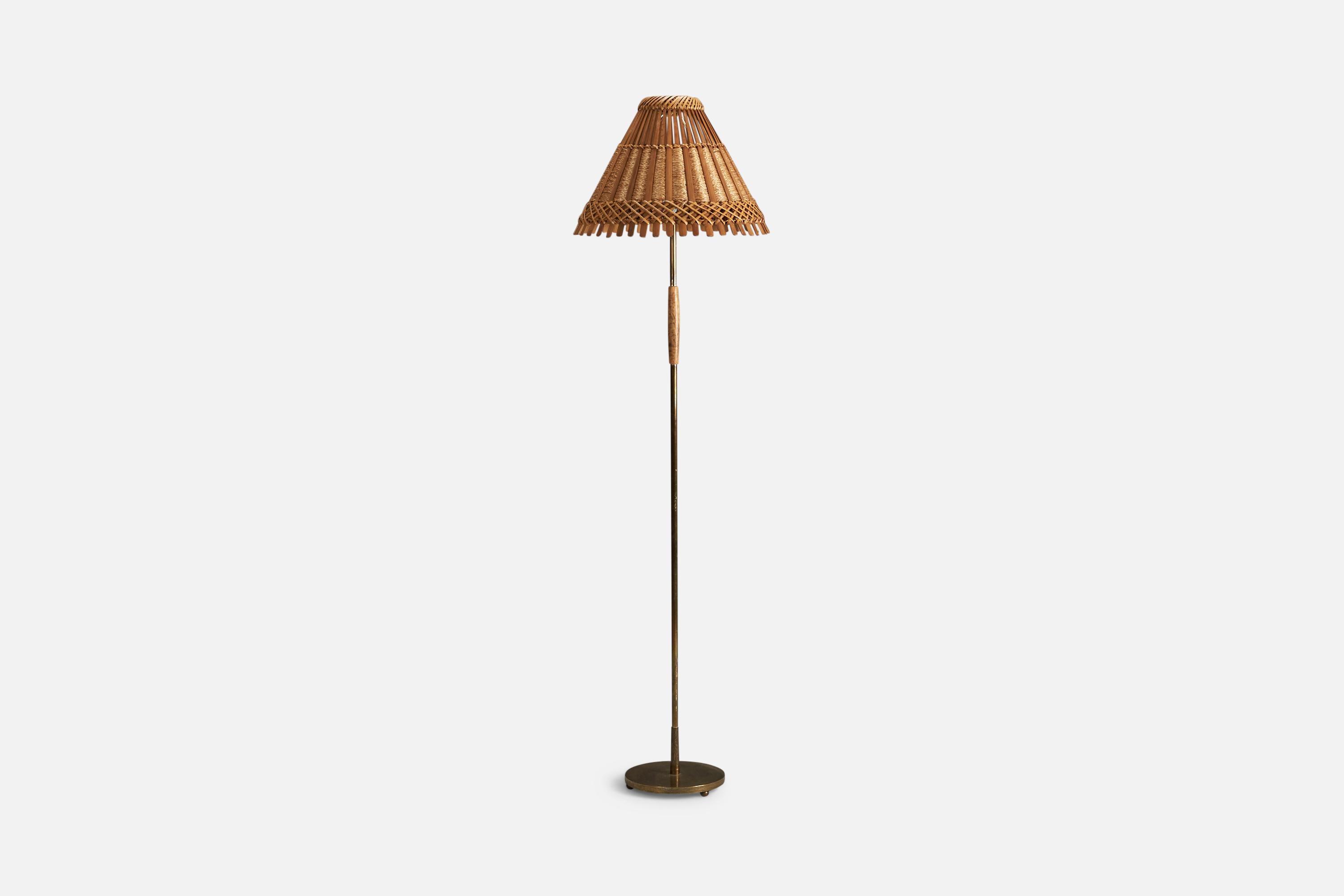 A brass, birch, rattan and raffia floor lamp designed and produced by a Swedish Designer, Sweden, 1950s.

Socket takes standard E-26 medium base bulb.

There is no maximum wattage stated on the fixture.