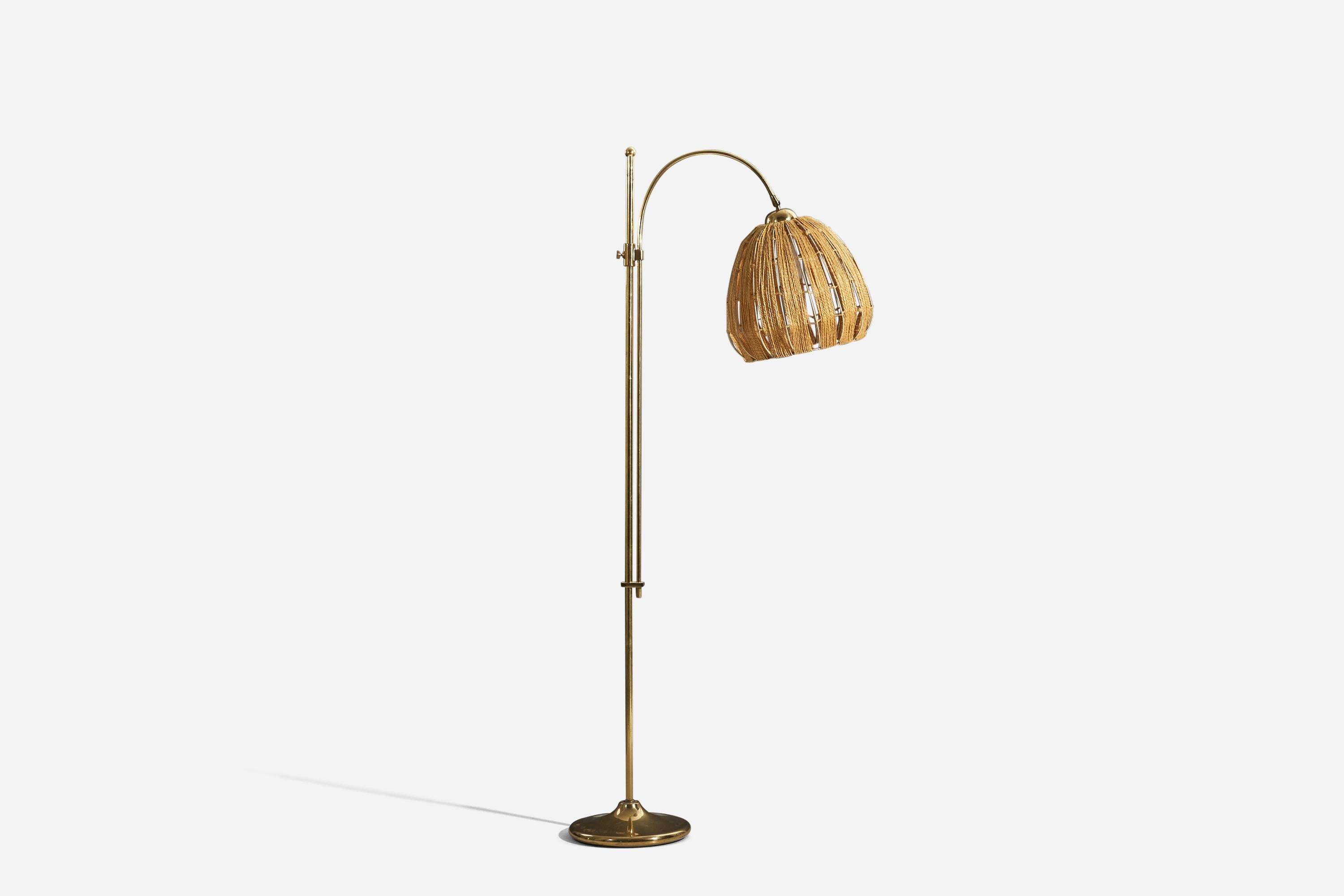 A brass and cord floor lamp designed and produced by a Swedish designer, Sweden, c. 1970s.

