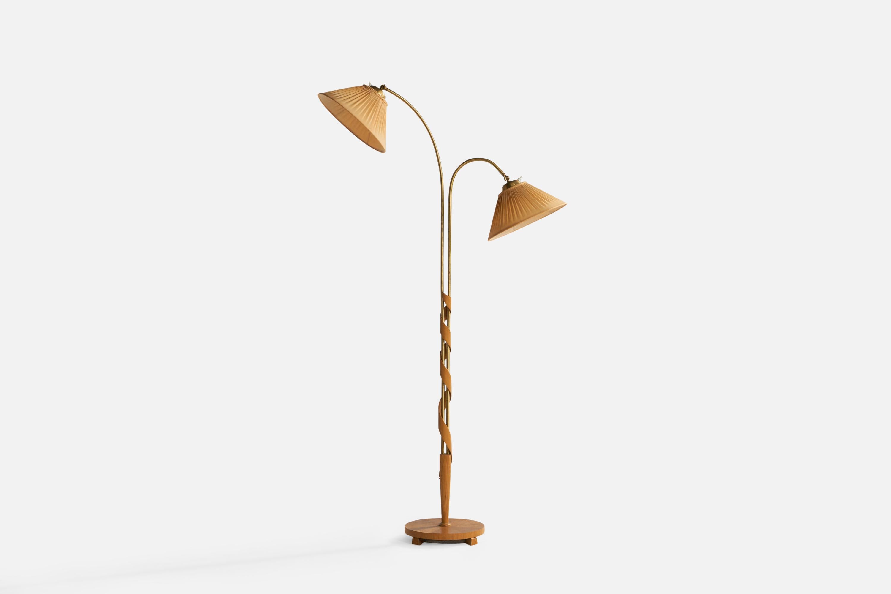 An adjustable two-armed brass, elm and beige fabric floor lamp designed and produced in Sweden, c. 1930s.

Overall Dimensions (inches): 64.7” H x 33.5” W x 12” Depth. Stated dimensions include shade.
Dimensions vary based on position of light.