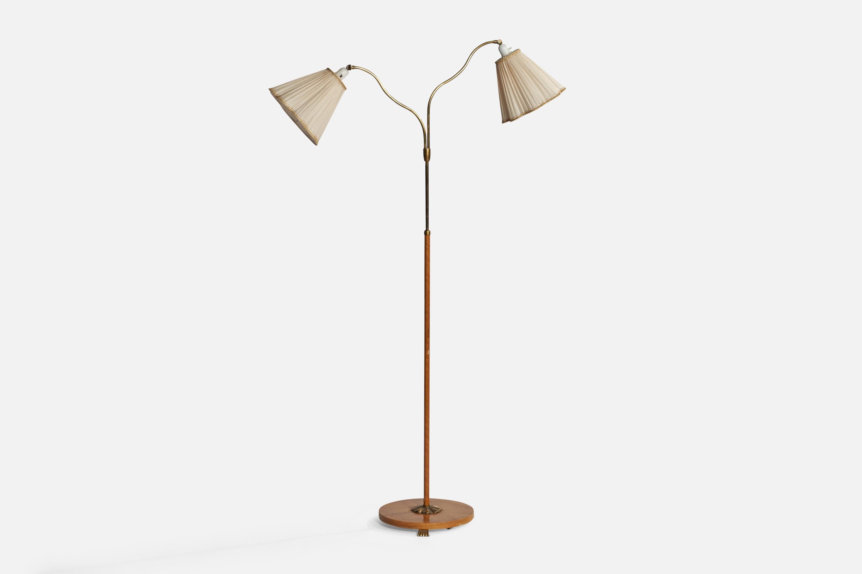 An adjustable organic brass, elm, wood veneer, bakelite and off-white fabric floor lamp designed and produced in Sweden, 1940s.

Overall Dimensions (inches): 66.25” H x 40.5” W x 14” D.Stated dimensions include shades.
Dimensions vary based on