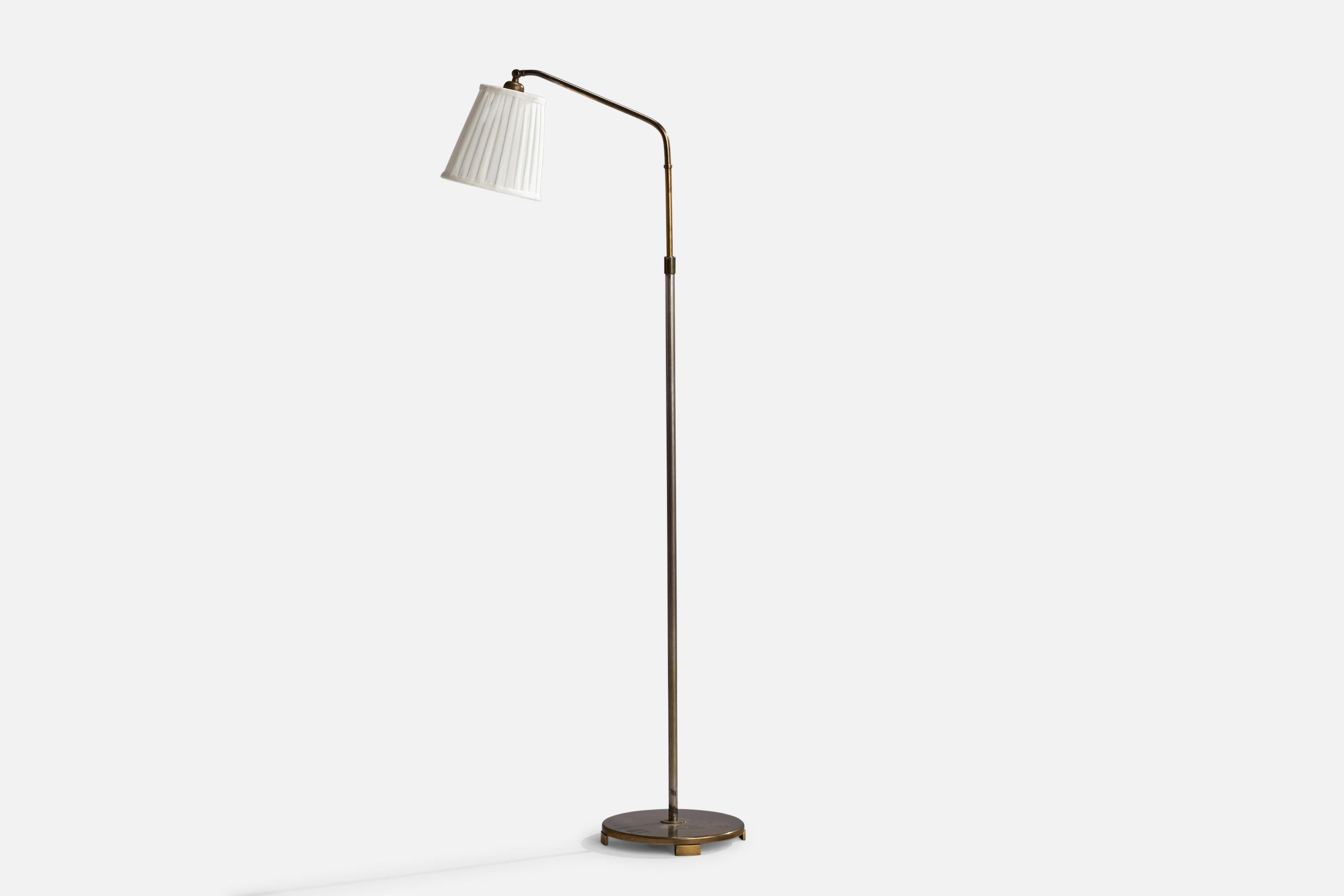 An adjustable brass, metal and off-white fabric floor lamp designed and produced in Sweden, 1940s.

Dimensions will vary depending upon adjustment.
Overall Dimensions (inches): 61” H x 11.25” W x 25”  D
Stated dimensions include shade.
Bulb