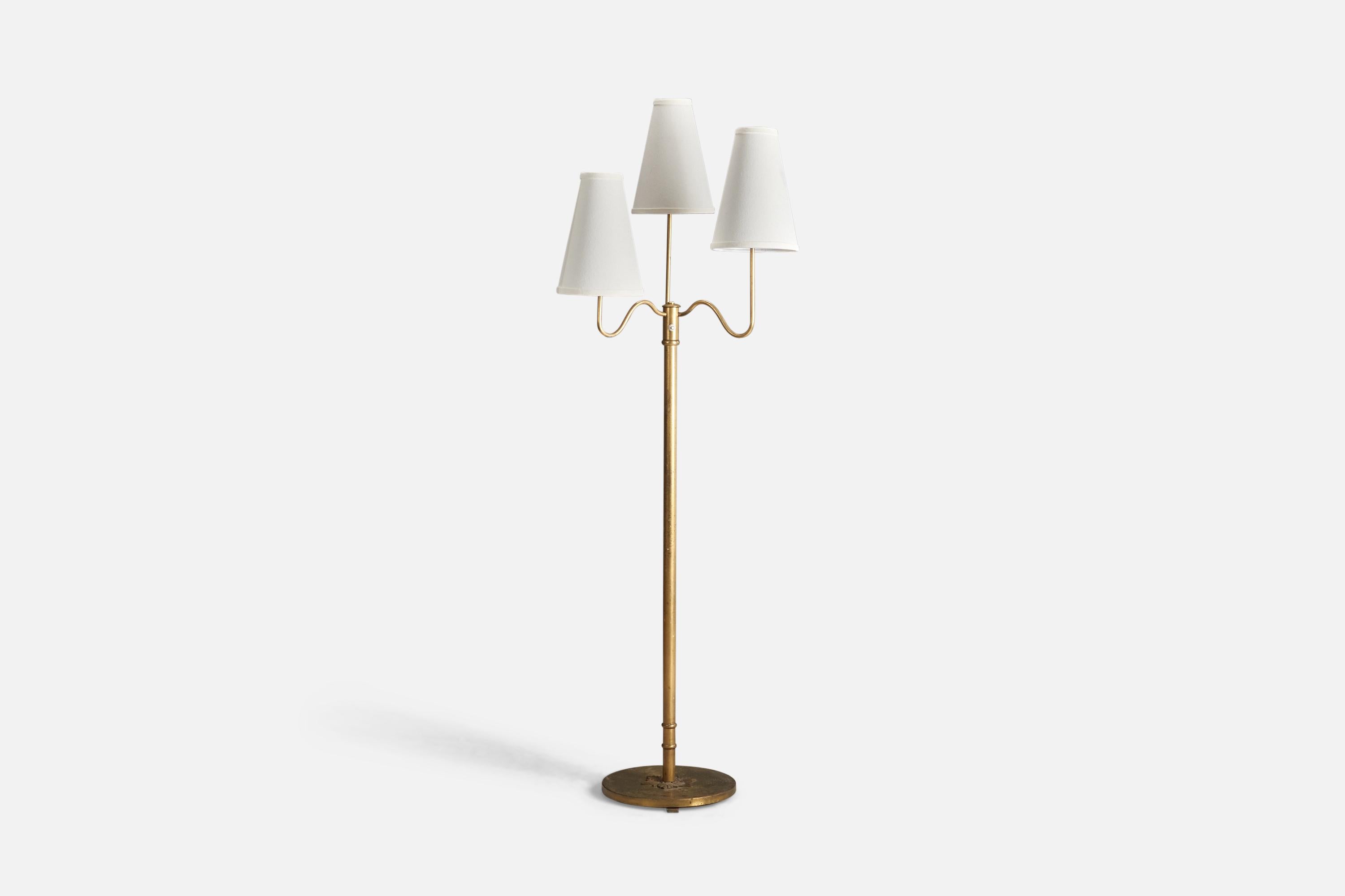 A brass and fabric floor lamp designed and produced by a Swedish Designer, Sweden, 1940s.

Sockets take standard E-26 medium base bulbs.

There is no maximum wattage stated on the fixture.