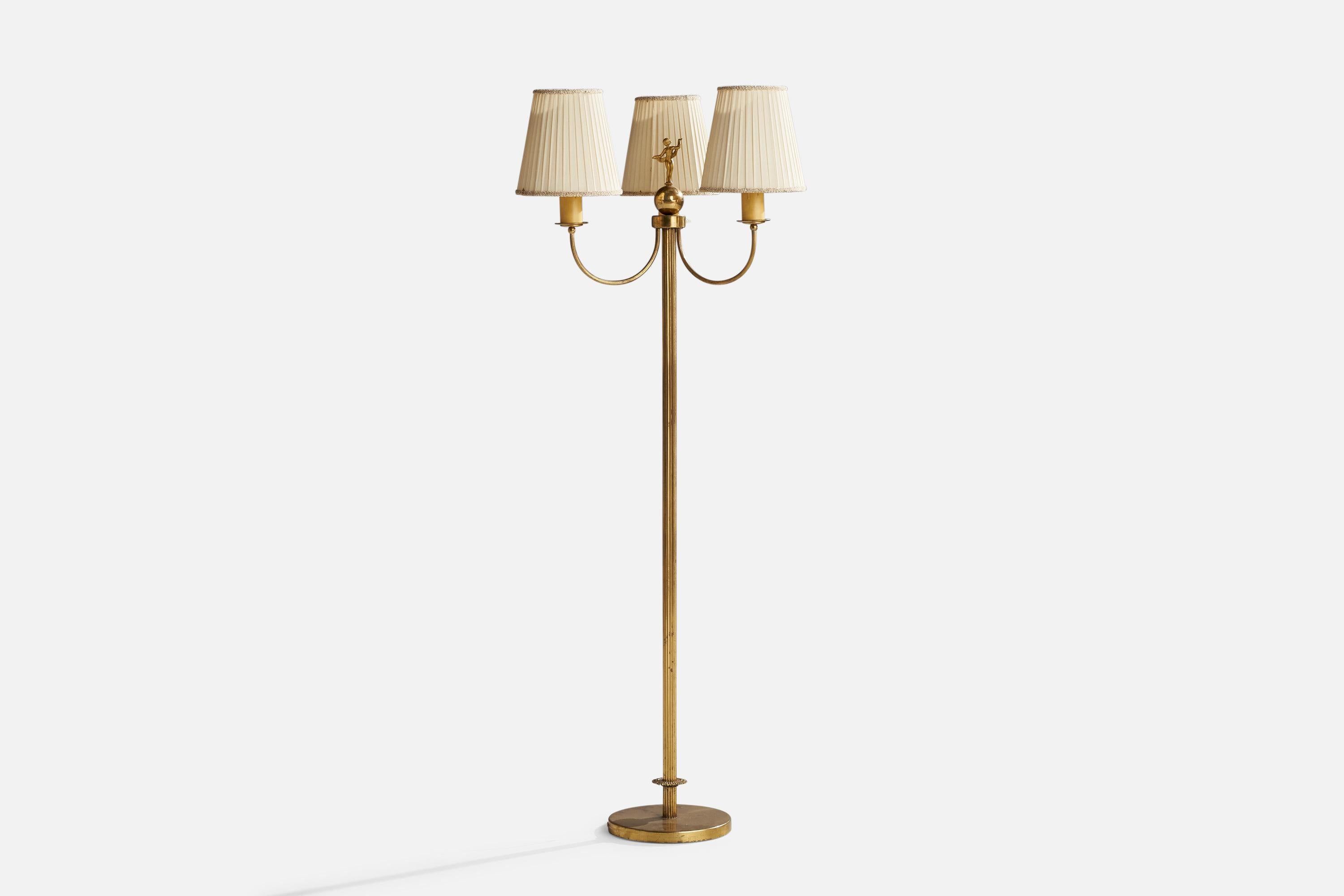 A brass, off-white fabric and bakelite floor lamp designed and produced in Sweden, 1940s.

Overall Dimensions (inches): 65”  H x 24” W x 23” D
Stated dimensions include shade.
Bulb Specifications: E-26 Bulb
Number of Sockets: 3
All lighting will be